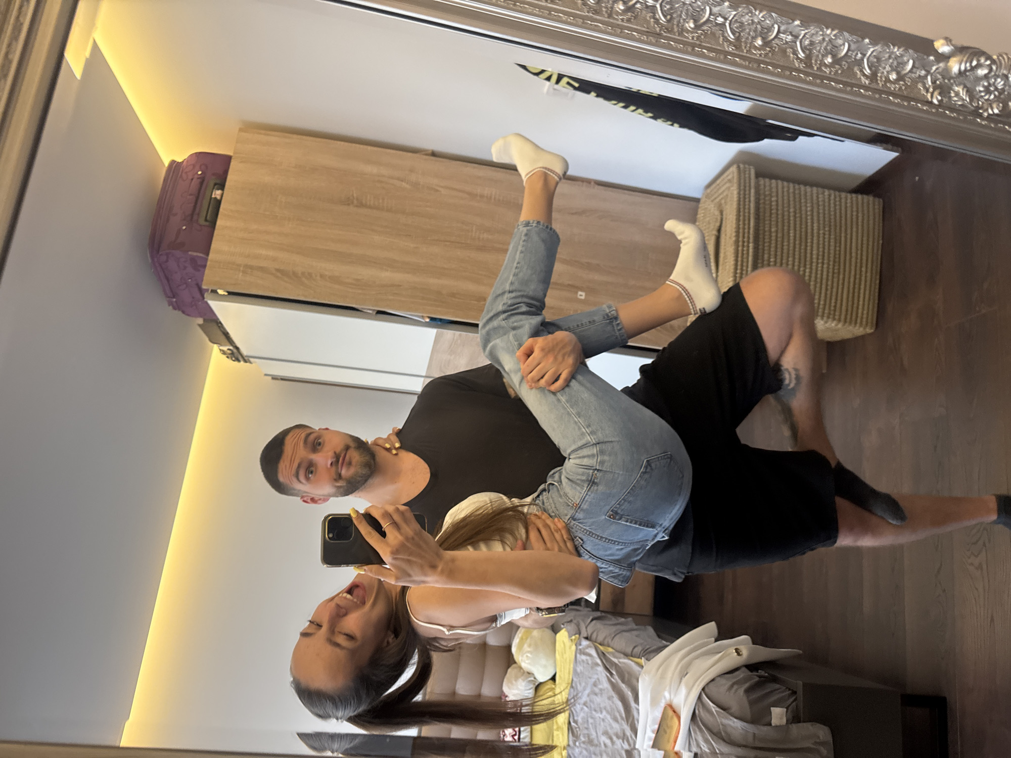 Couple Takes Multiple Selfies in Sofia Bedroom