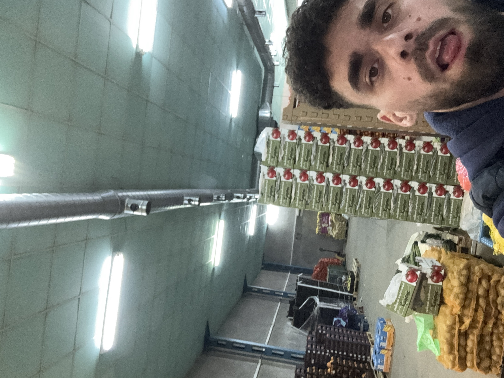 Man photographed with mouth open in warehouse setting