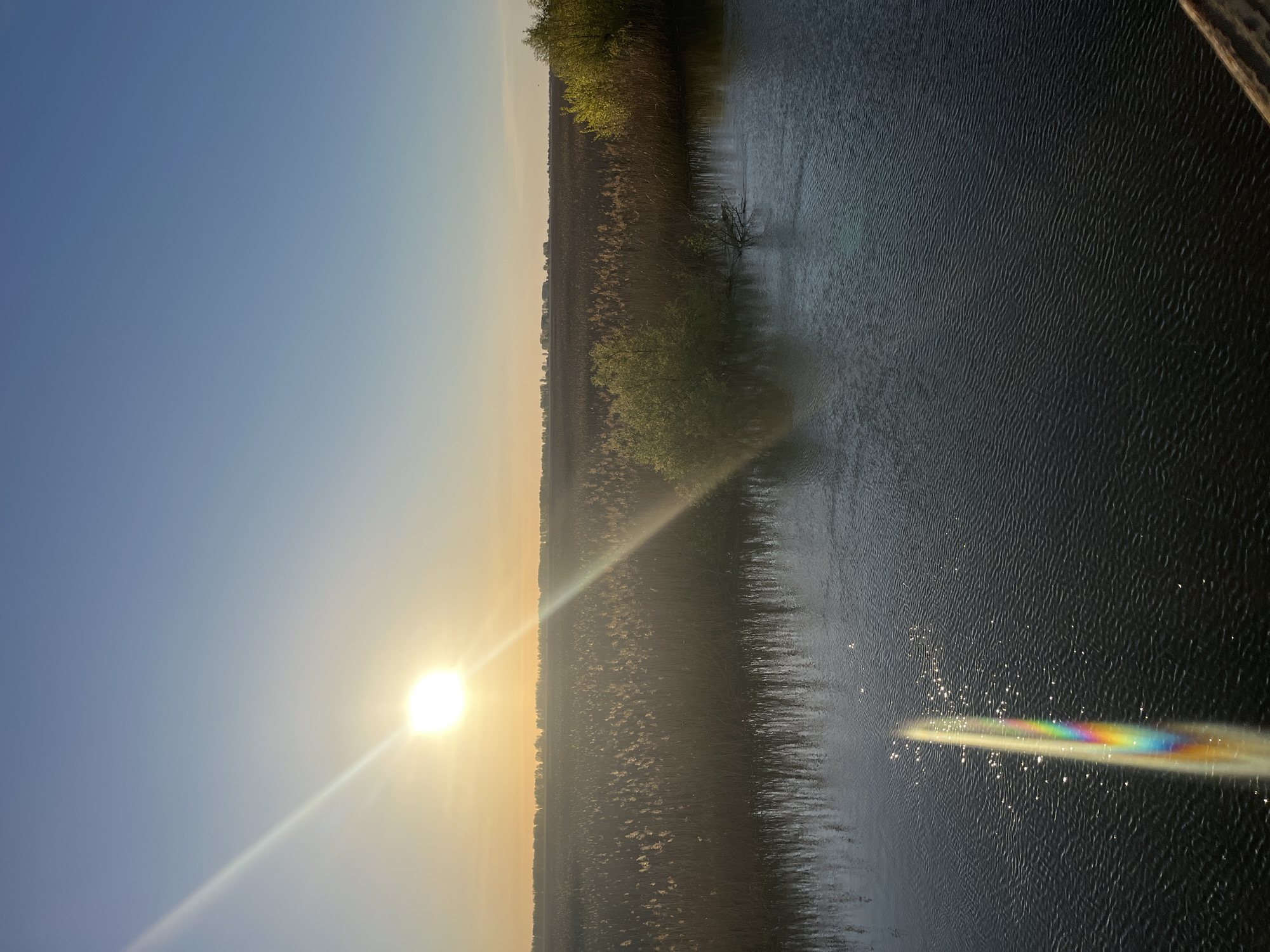 Dawn landscape with reflective water documented in Karalat, Russia