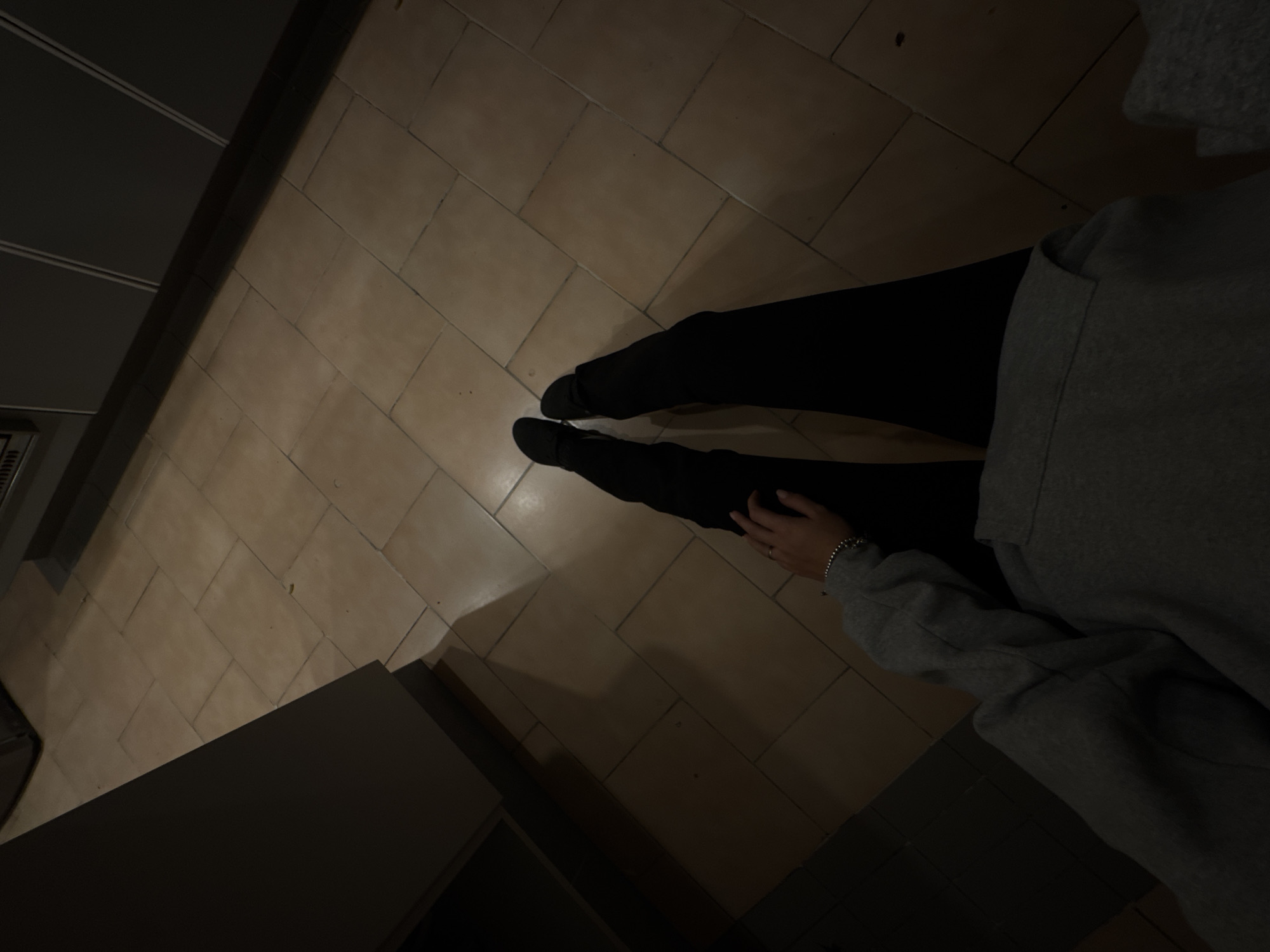 Person sits on kitchen floor in Mexico City home