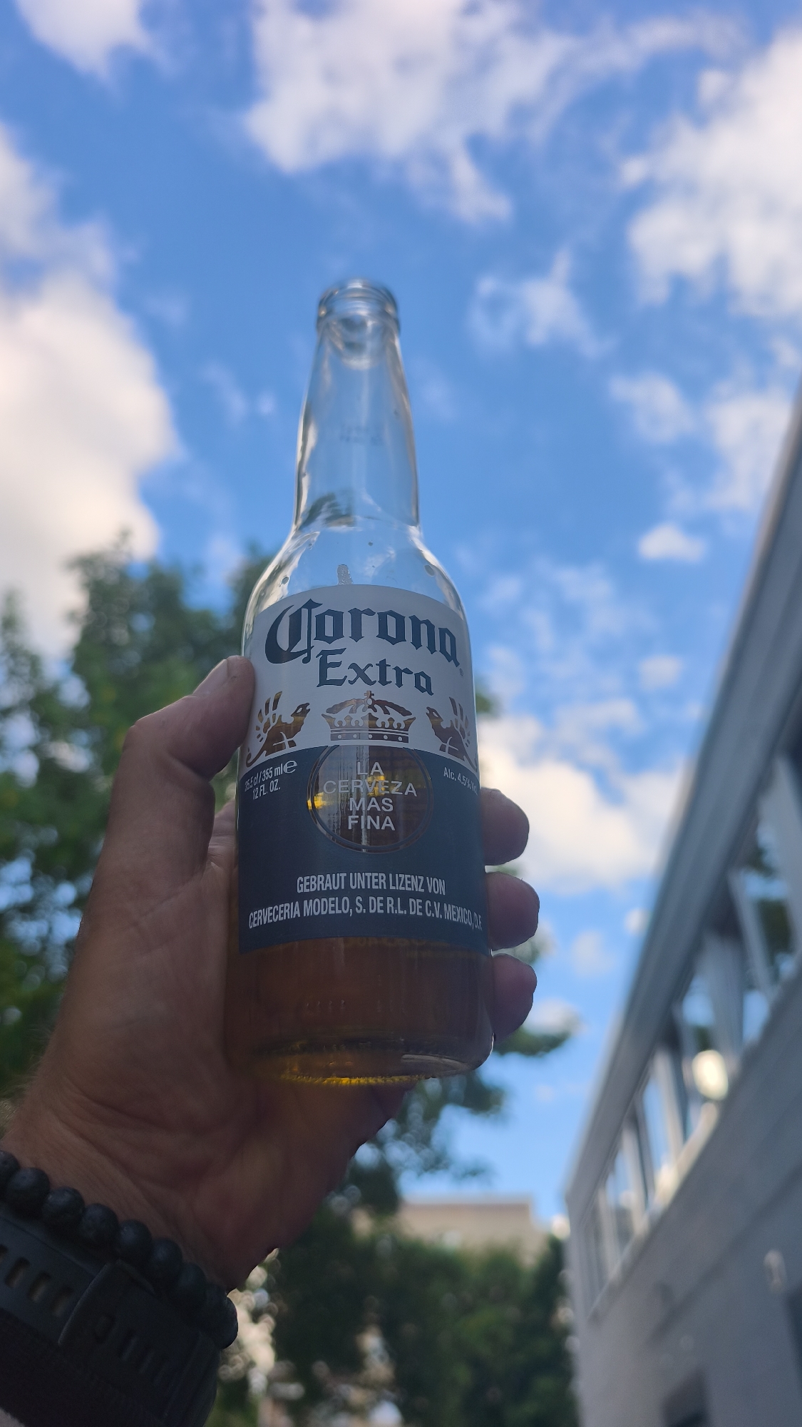 Man enjoys Corona beer outdoors under summer sky