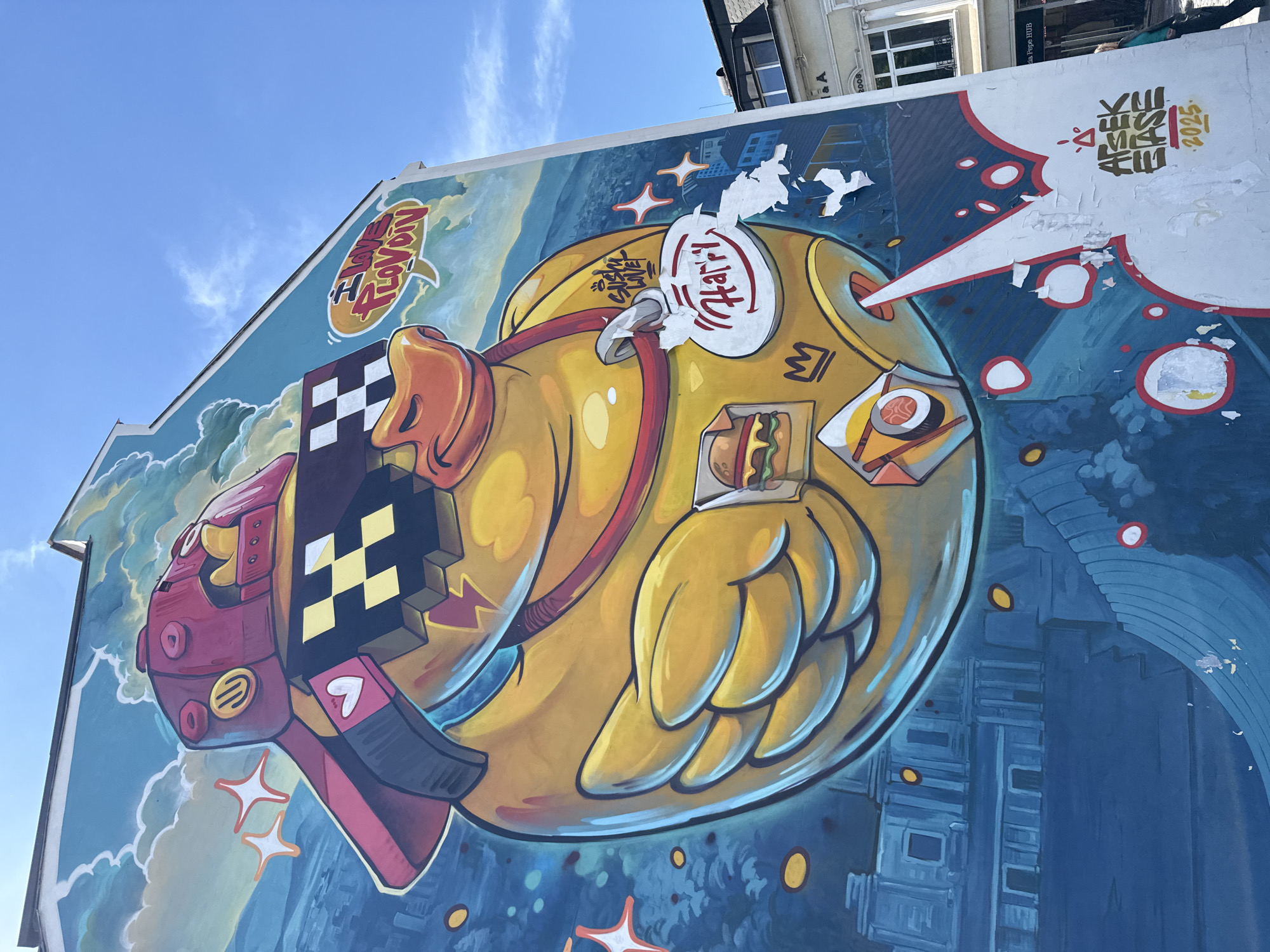 Yellow duck mural with pixelated design spotted on building