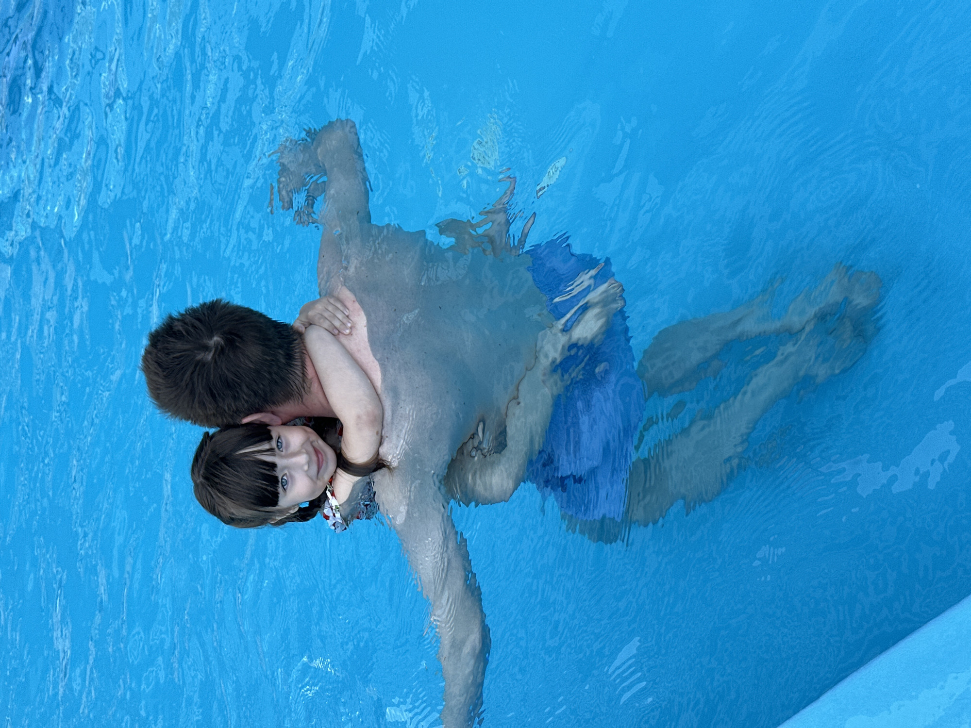 Father and daughter enjoy morning swim in Sochi pool