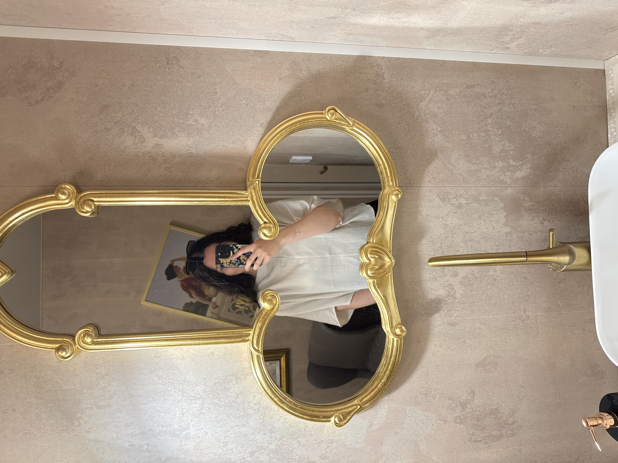 Witnesses document unusual gold mirror design in bathroom interior