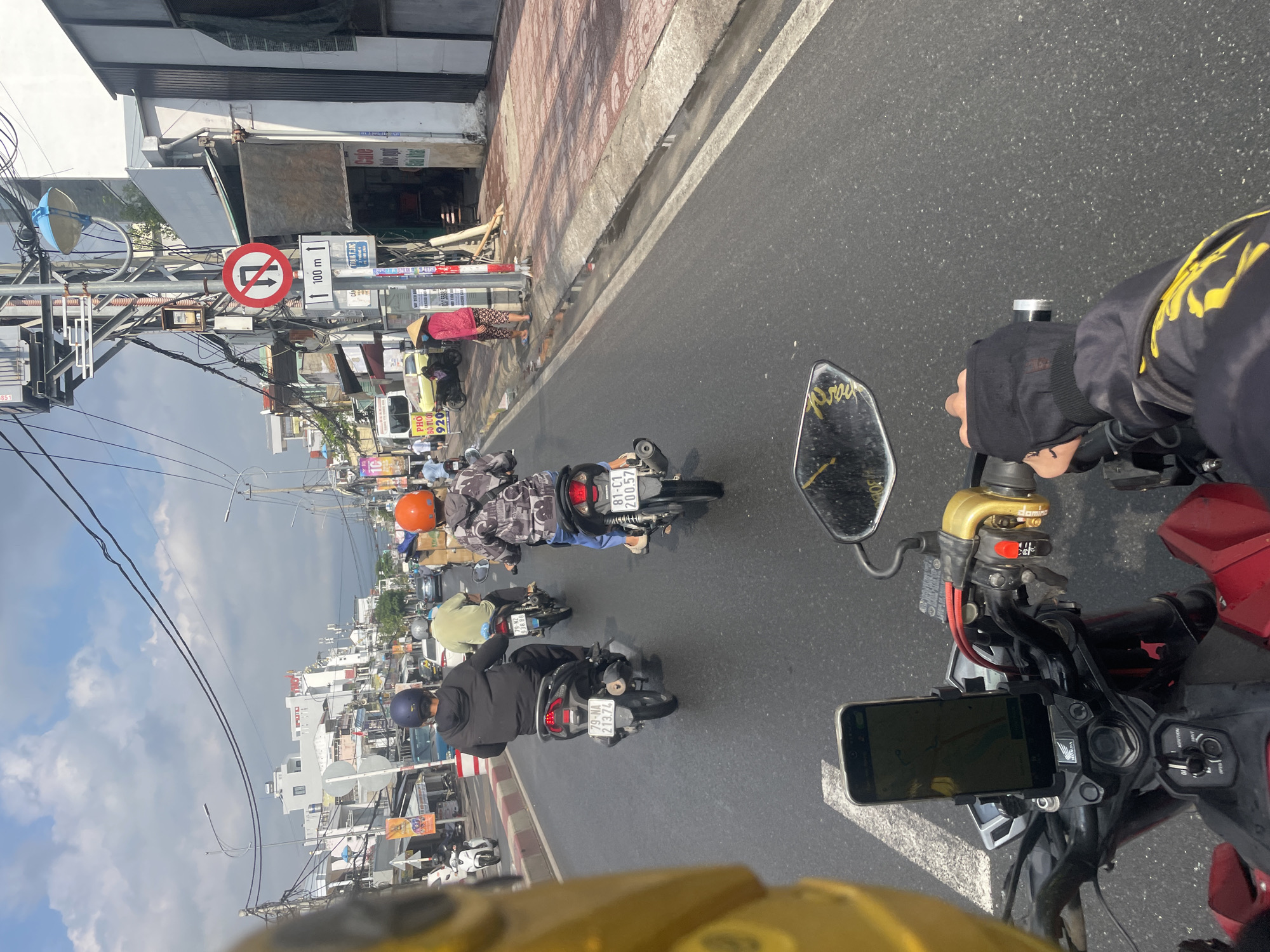 Motorbike traffic navigates wet streets in Nha Trang
