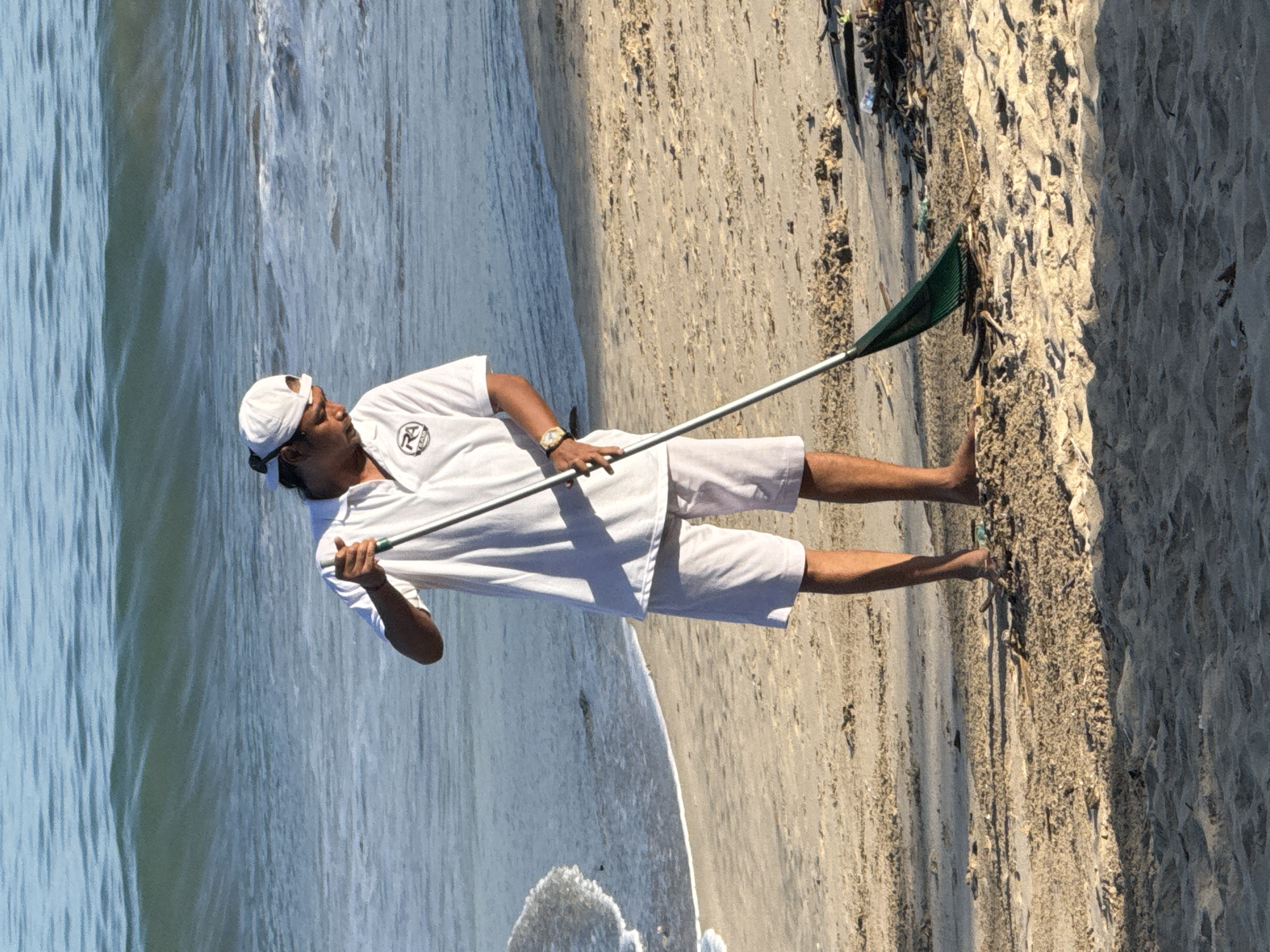 Man conducts beach cleanup in Kuta Selatan, Indonesia