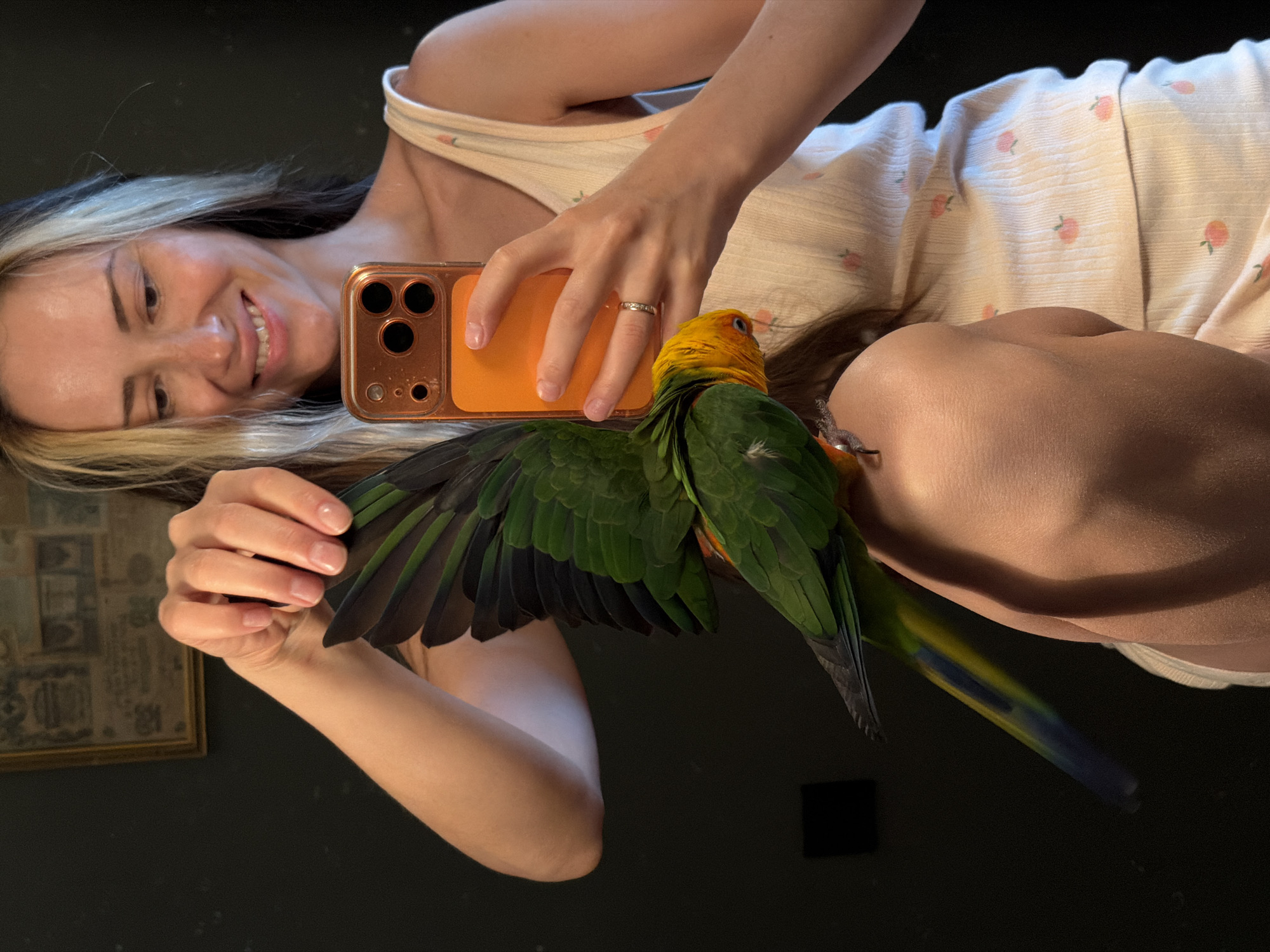 Woman bonds with Sun Conure parrot in early morning Khimki