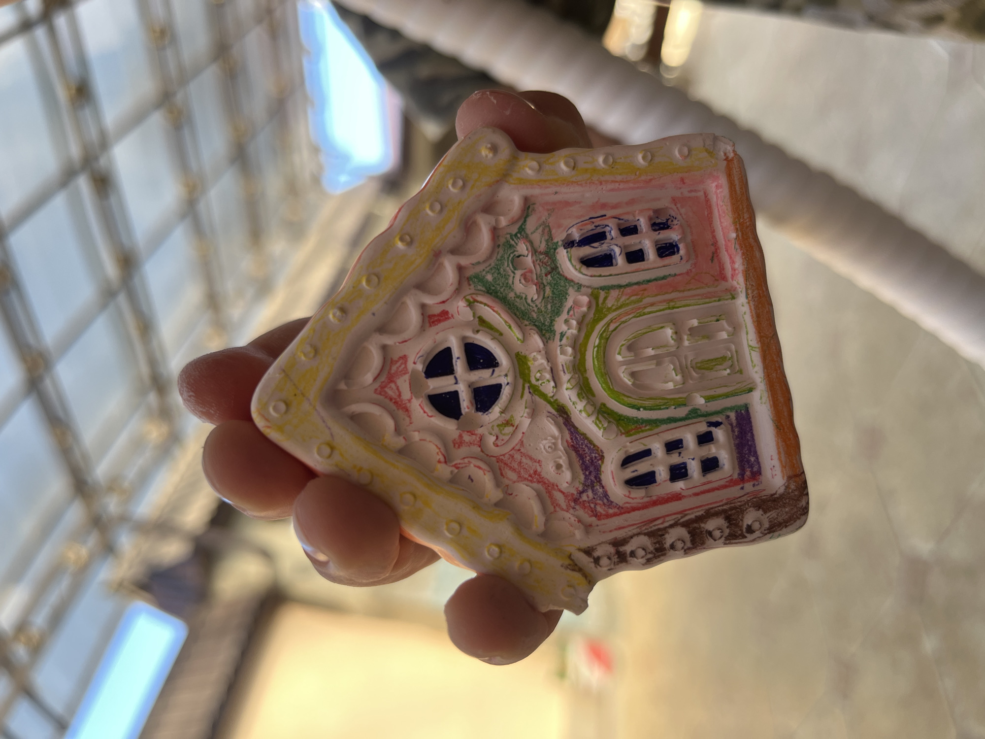 Boy displays painted clay house ornaments in Kaspiysk