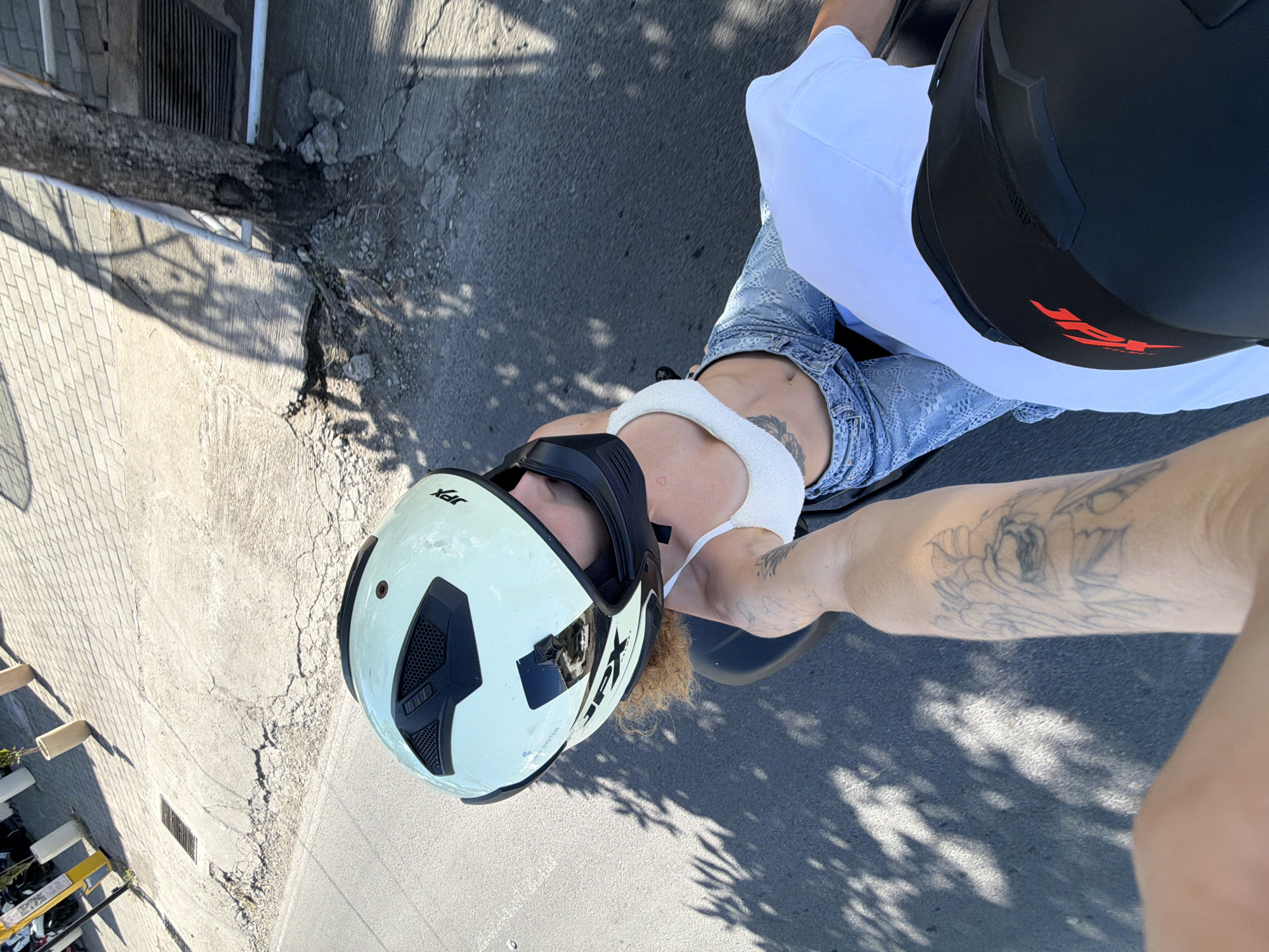 Motorcycle riders capture selfies during morning ride through North Kuta