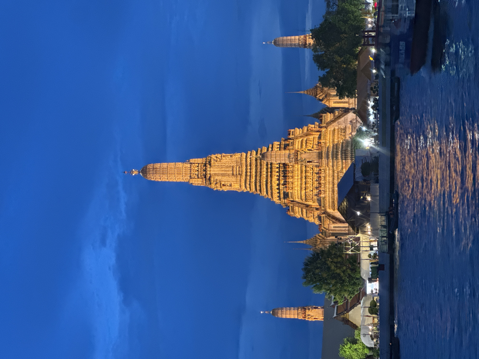 Wat Arun glowing at dusk along the Chao Phraya