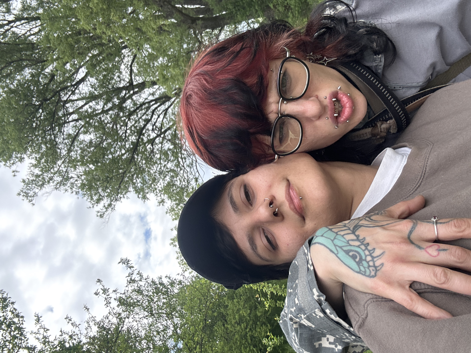 Two people photograph near Sofia church in grassy field