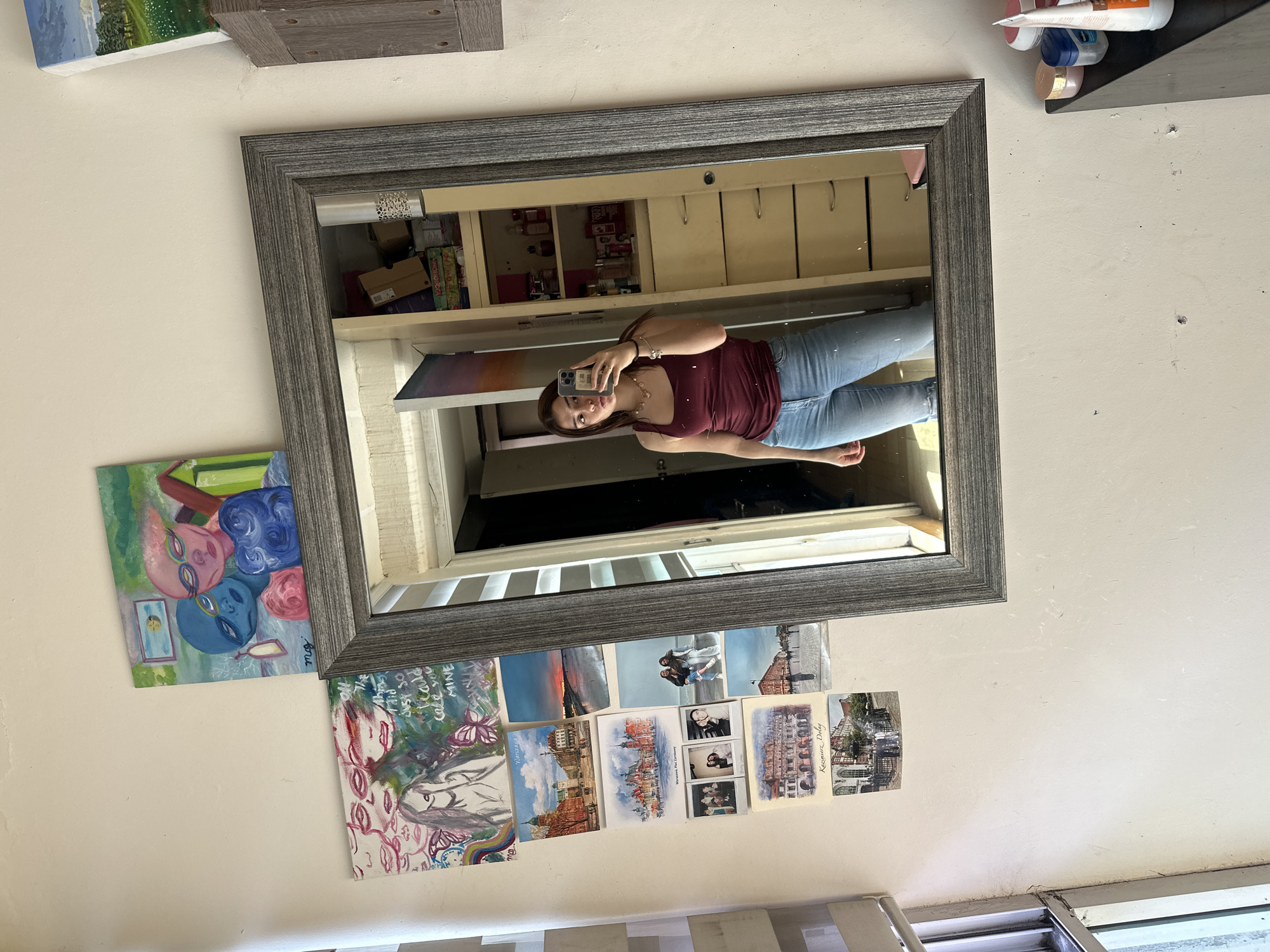 Woman takes mirror selfie in decorated room in Puebla