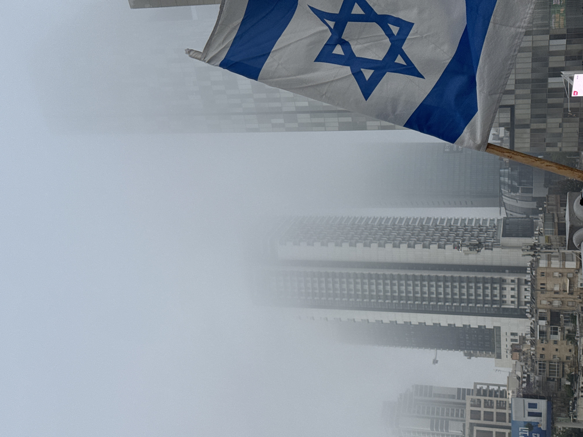 Israeli flag displayed amid foggy Ramat Gan cityscape
