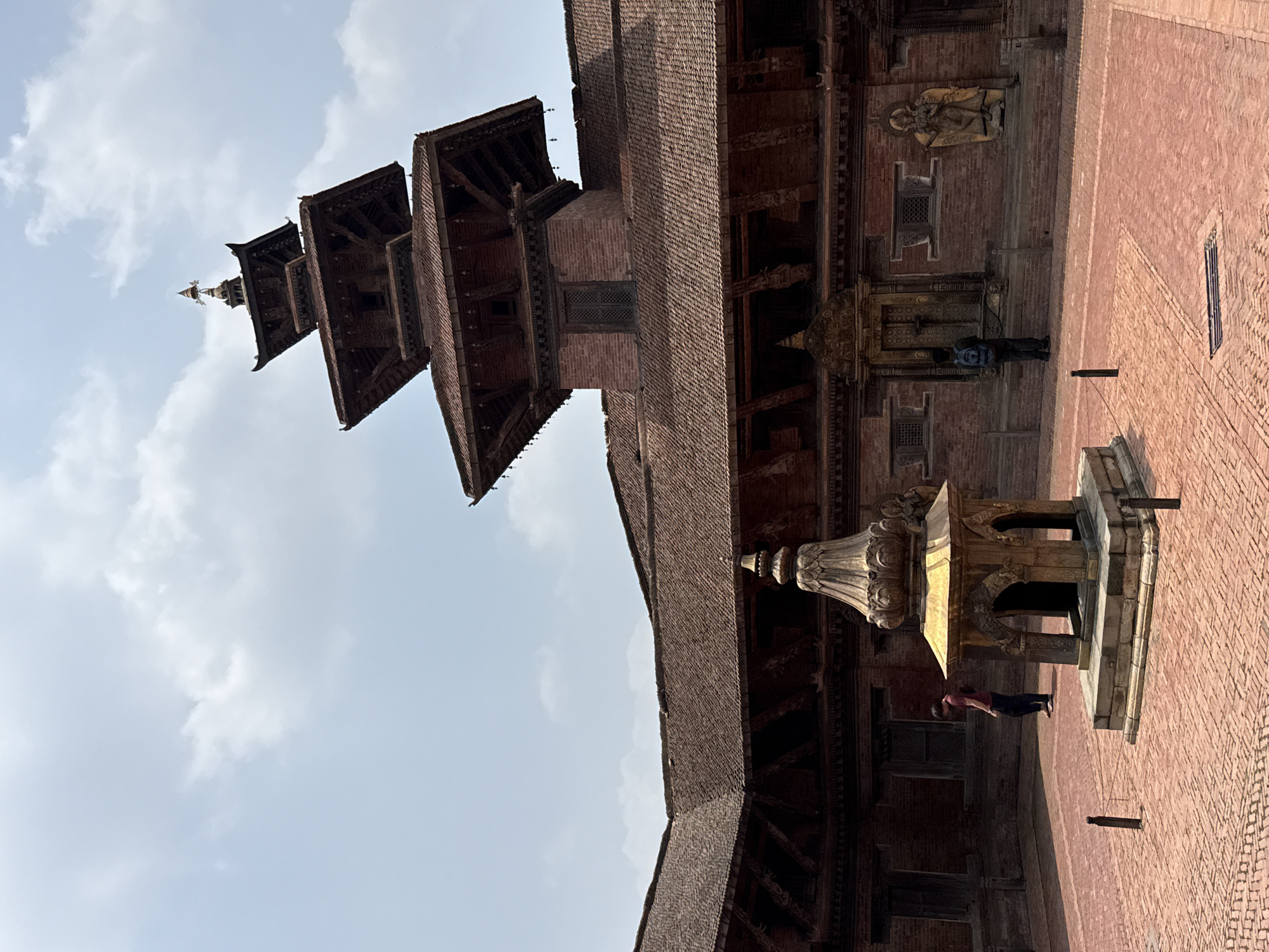 Tourist documents historic temples and sculptures at Patan Durbar Square