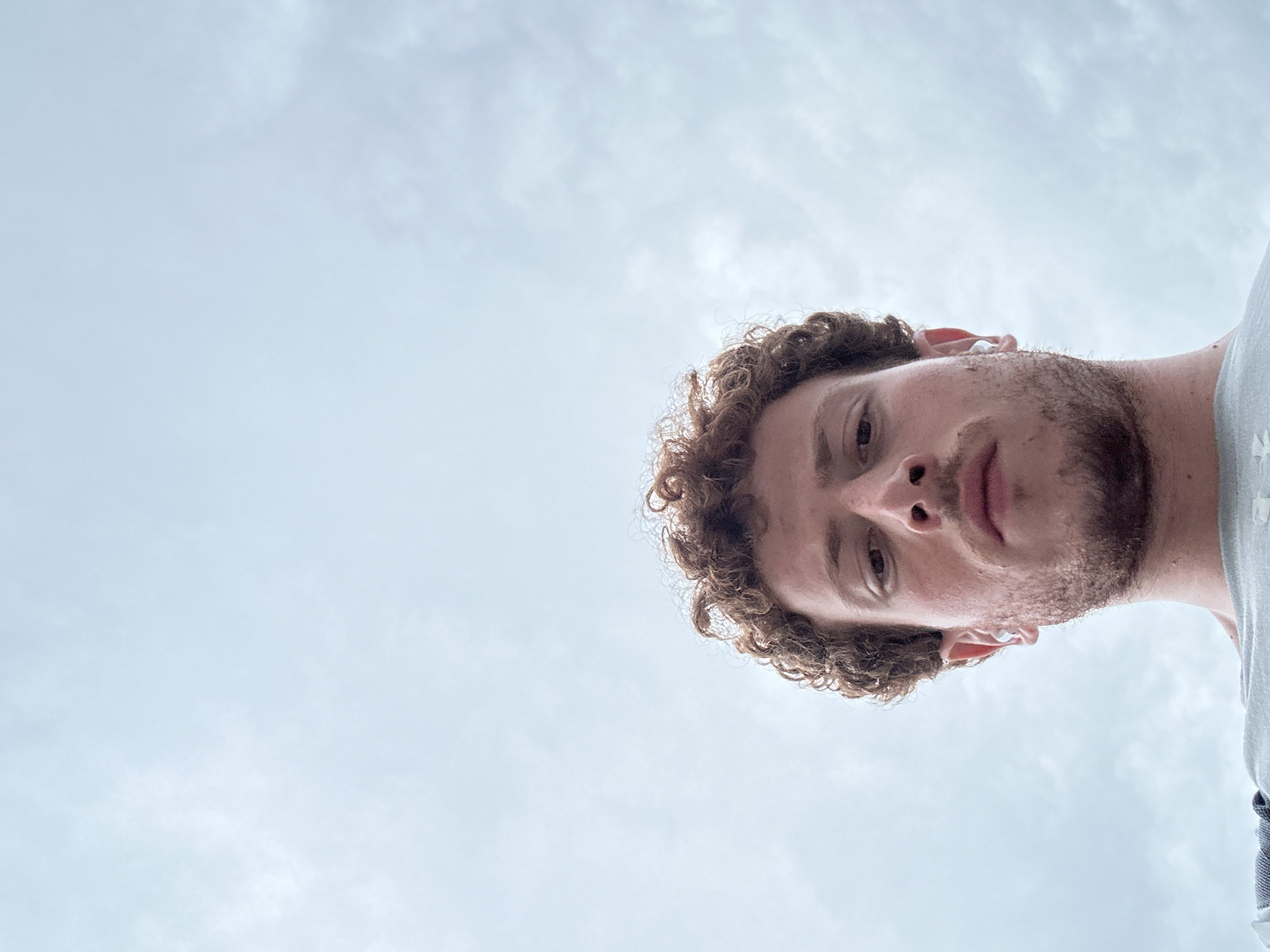 Person with earbuds photographed in close-up in New York