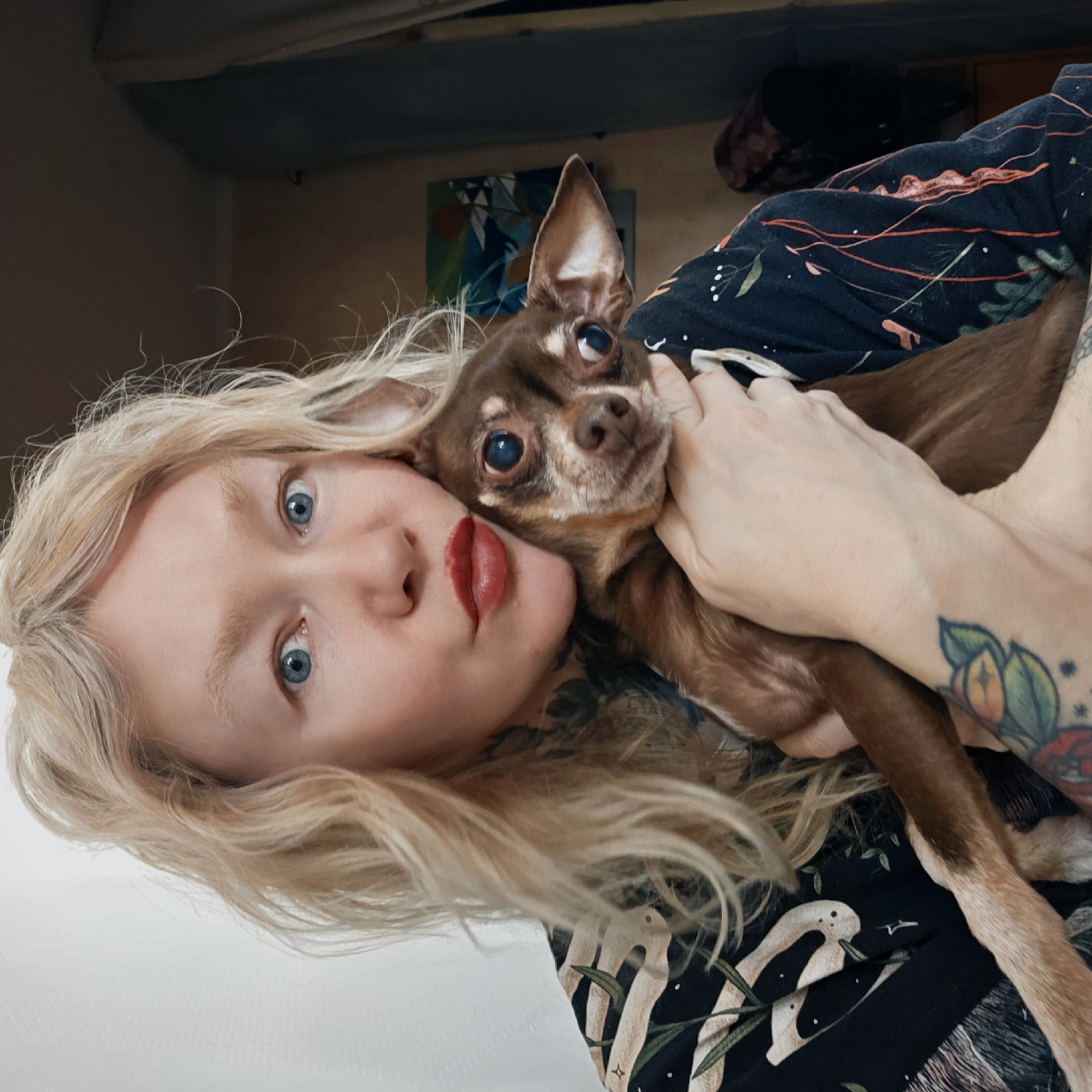 Woman poses with chihuahua in morning portrait session