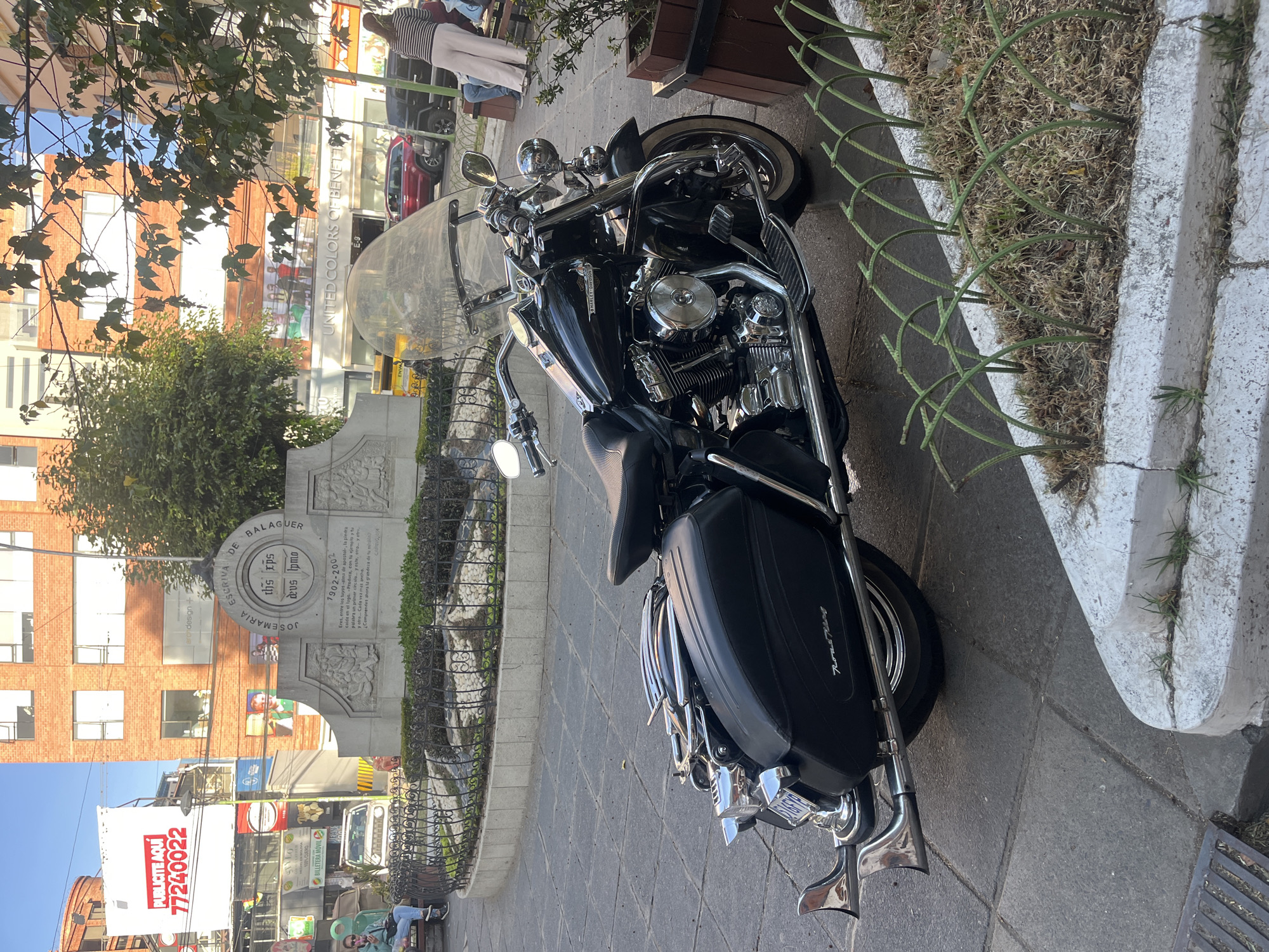 Motorcycle parked near Josemaria Escriva monument in La Paz