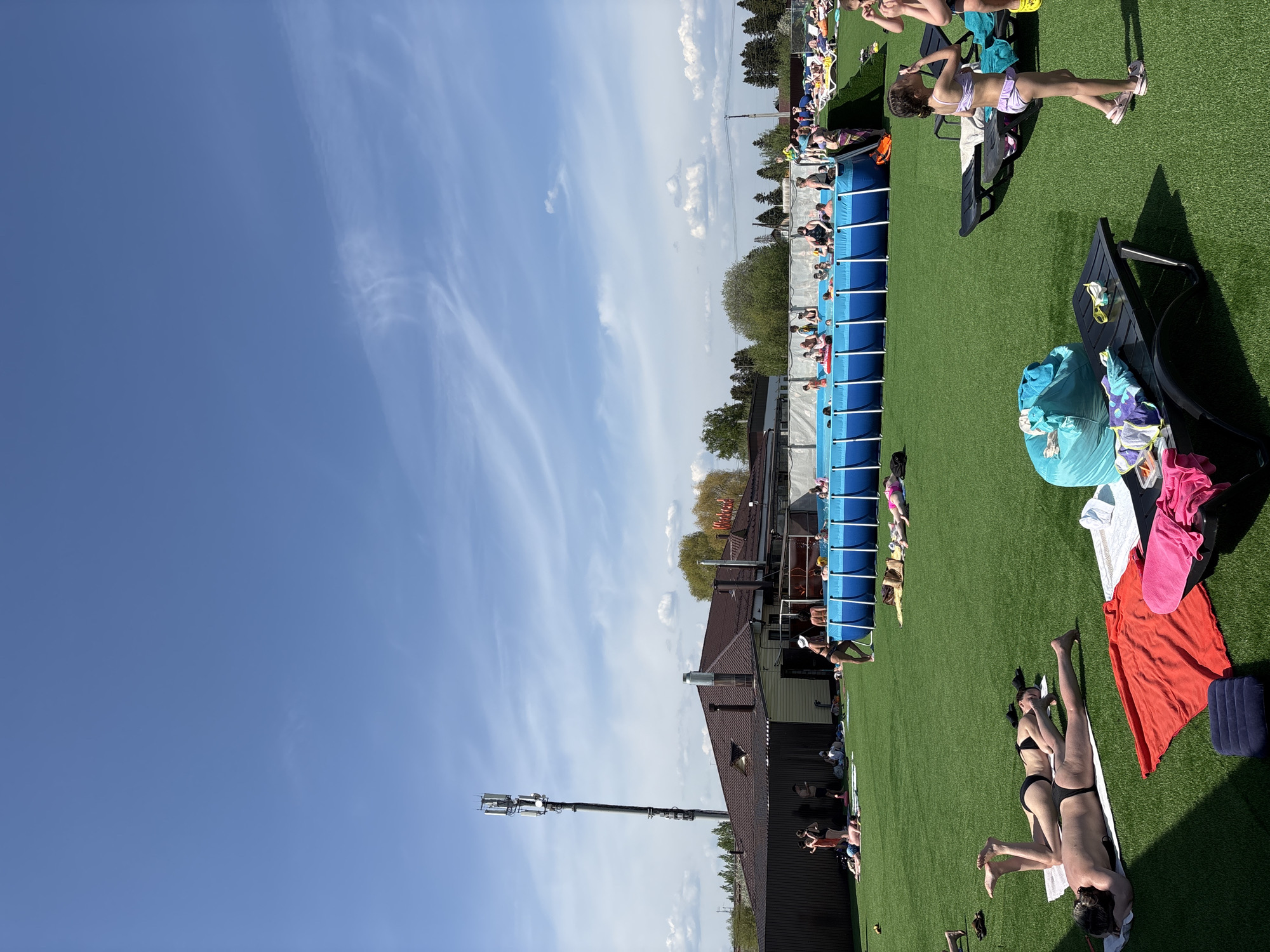 Swimmers and sunbathers enjoy outdoor pool in Гамово, Russia