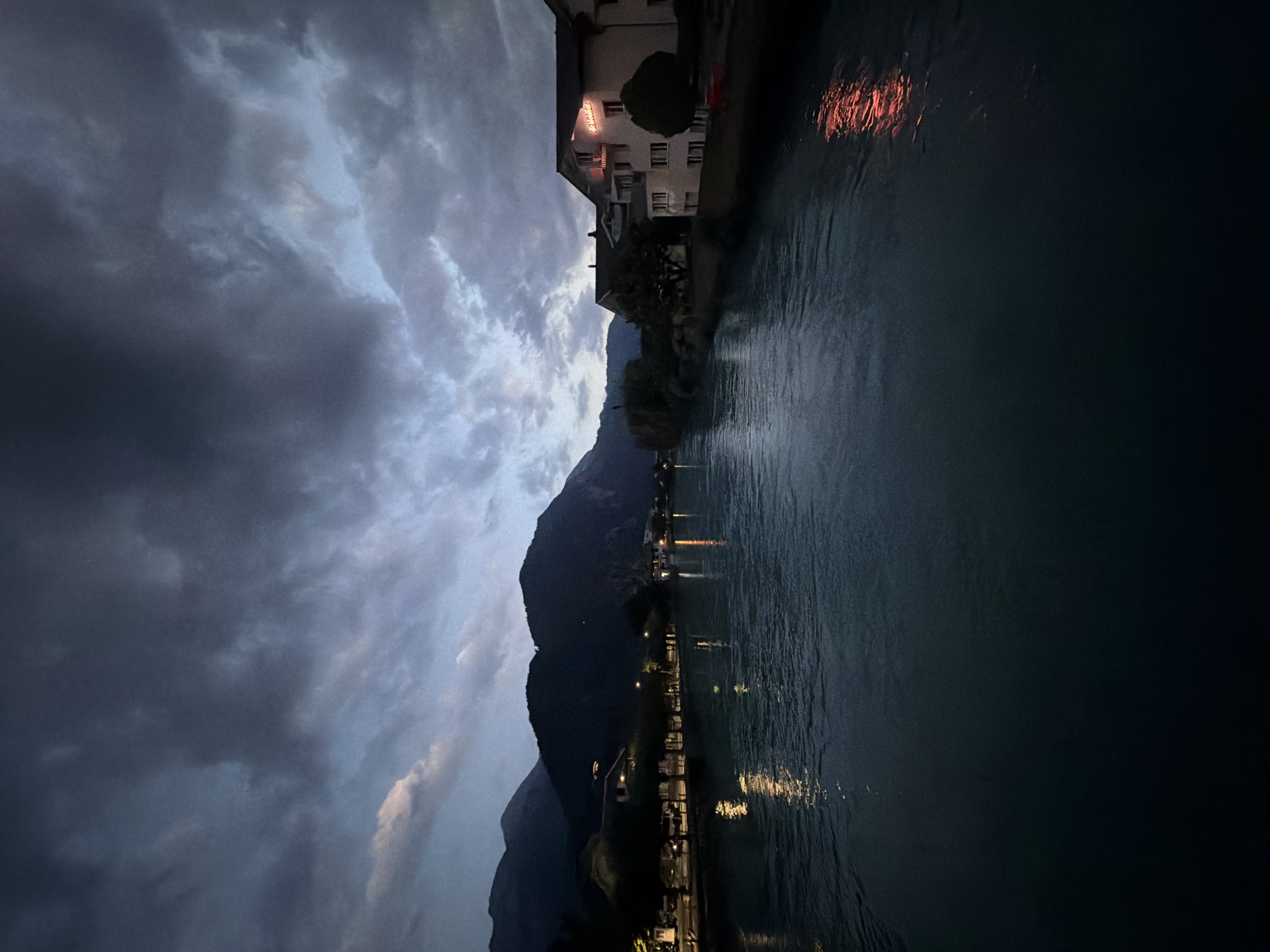 Interlaken at dusk: river, grand hotel, horse-drawn carriage