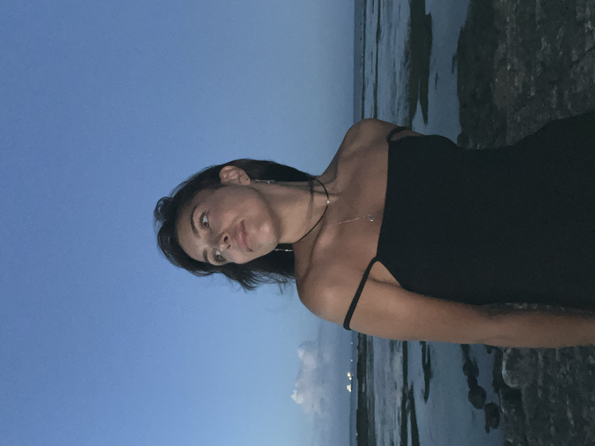 Woman poses for dusk photo session on Kuta coastline