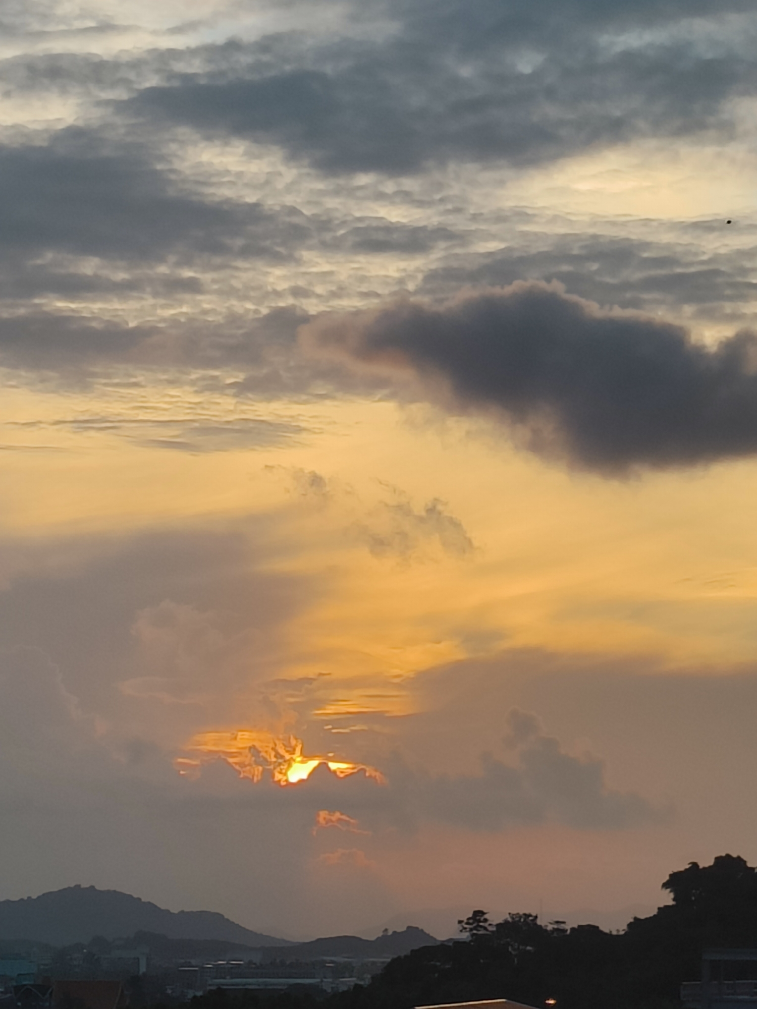 City sunset with dramatic cloud colors across the skyline