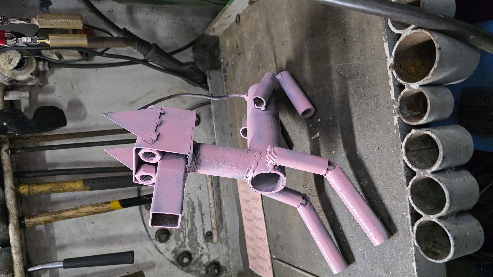 Pink Metal Horse Sculpture Spotted on Workshop Bench