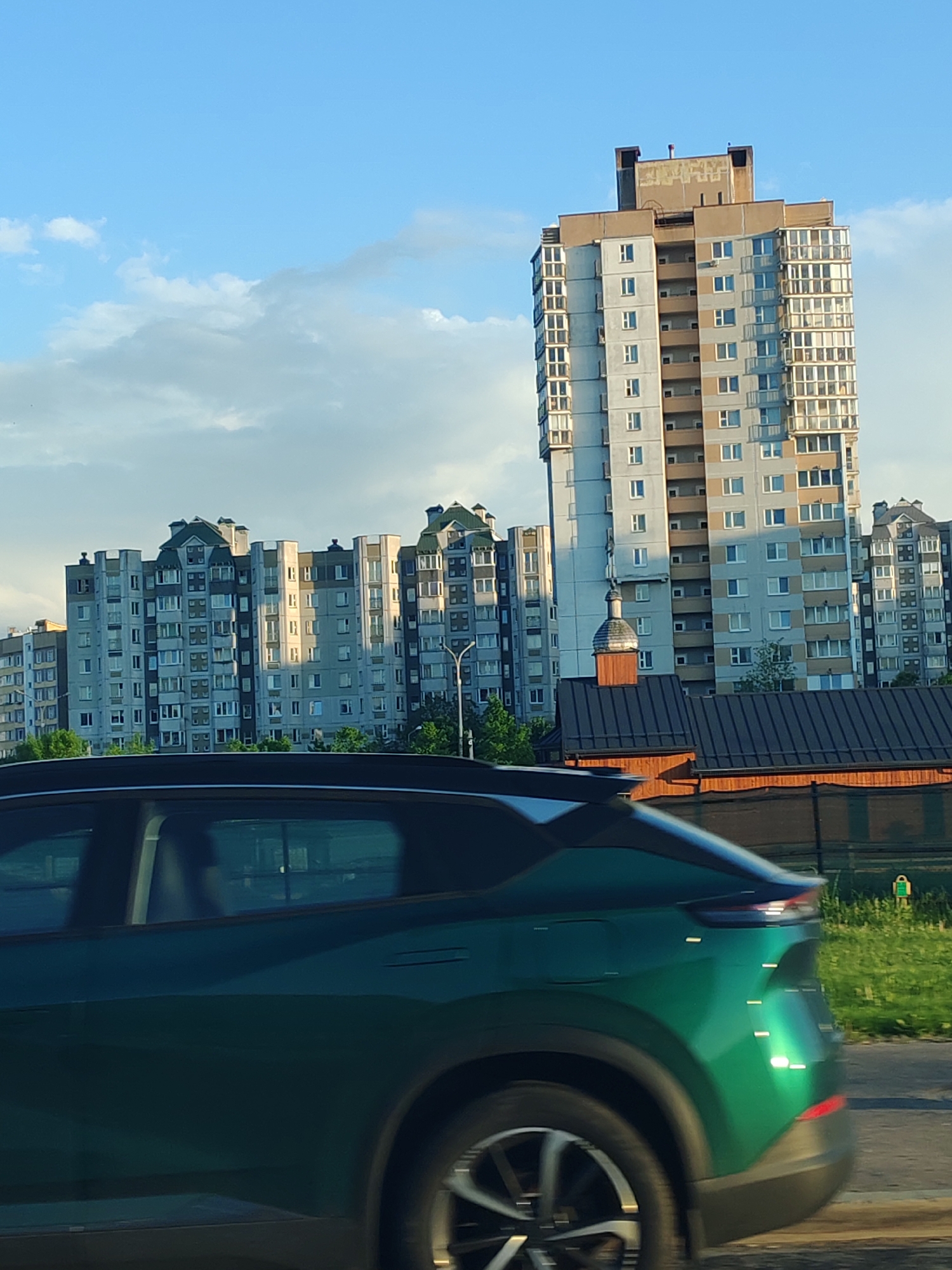 Car journey captures urban buildings, gardens, and countryside landscapes
