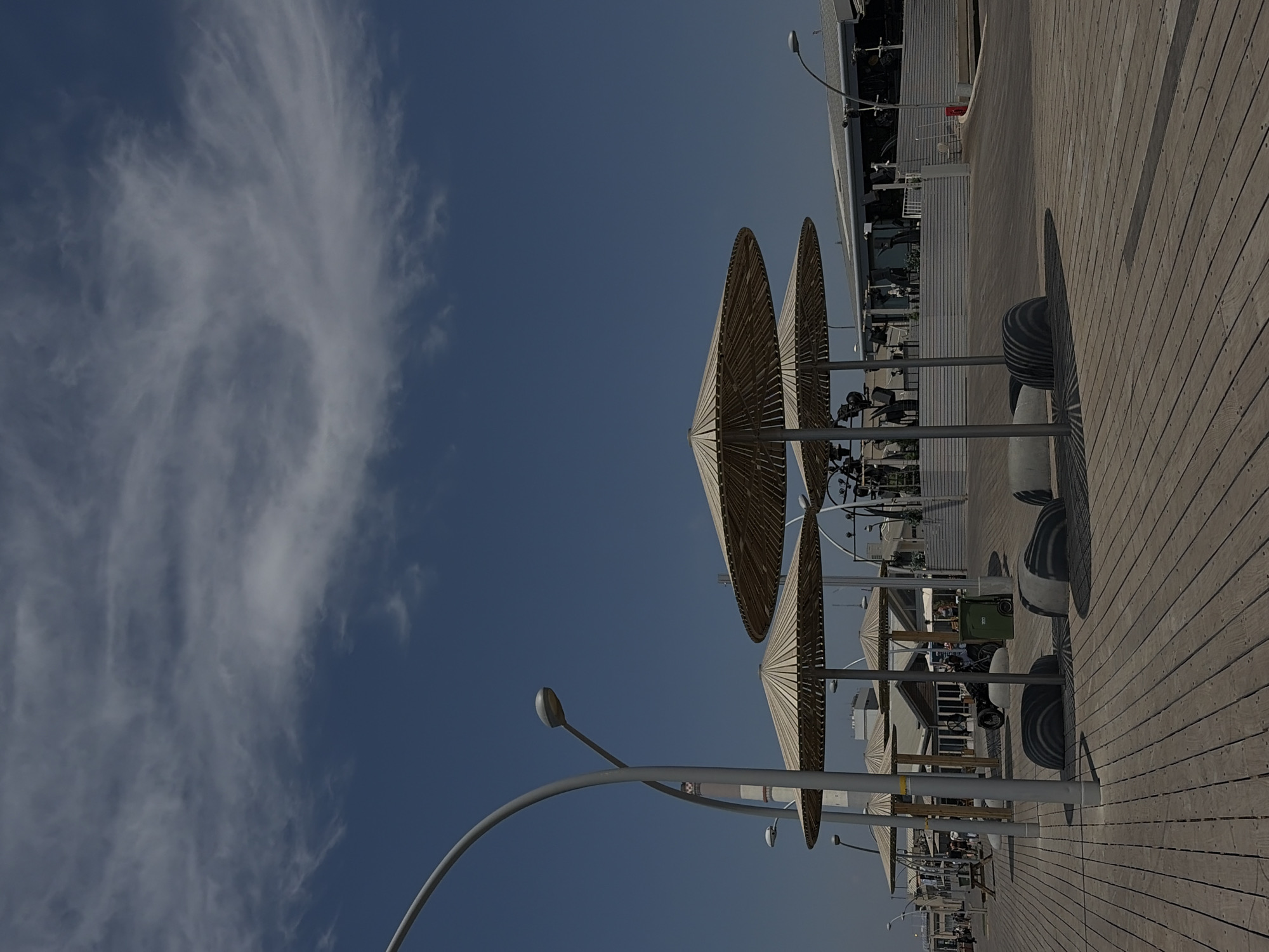 Person documents Tel Aviv waterfront scenes during morning visit