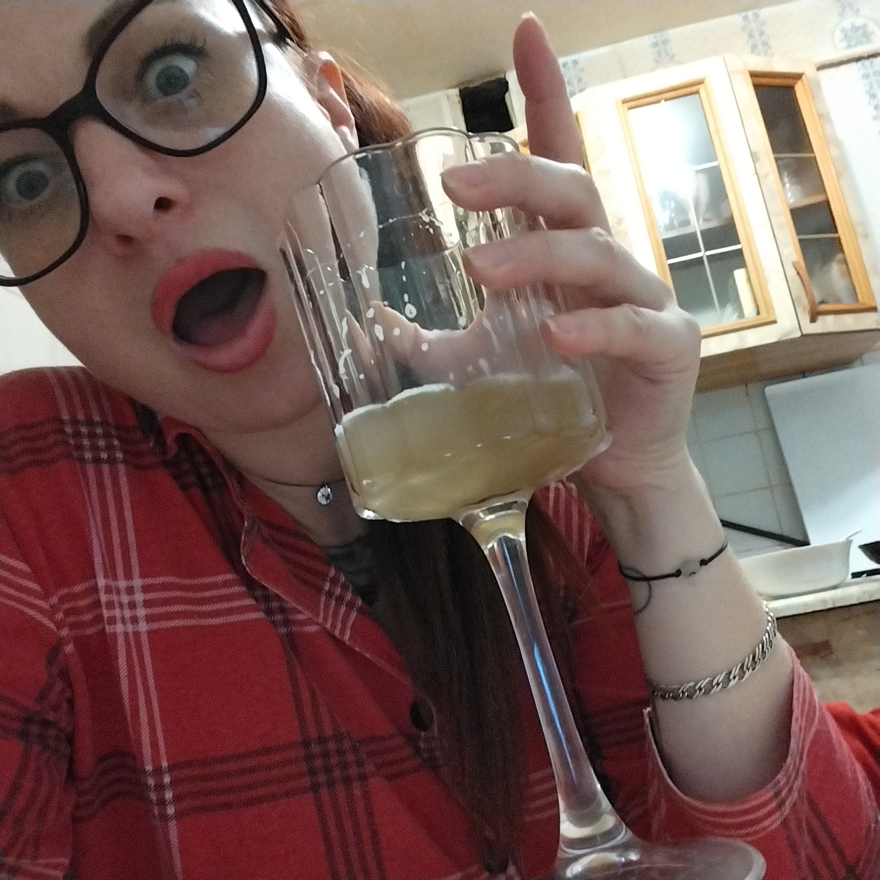 Couple celebrates at home with cats, drinks, and selfies