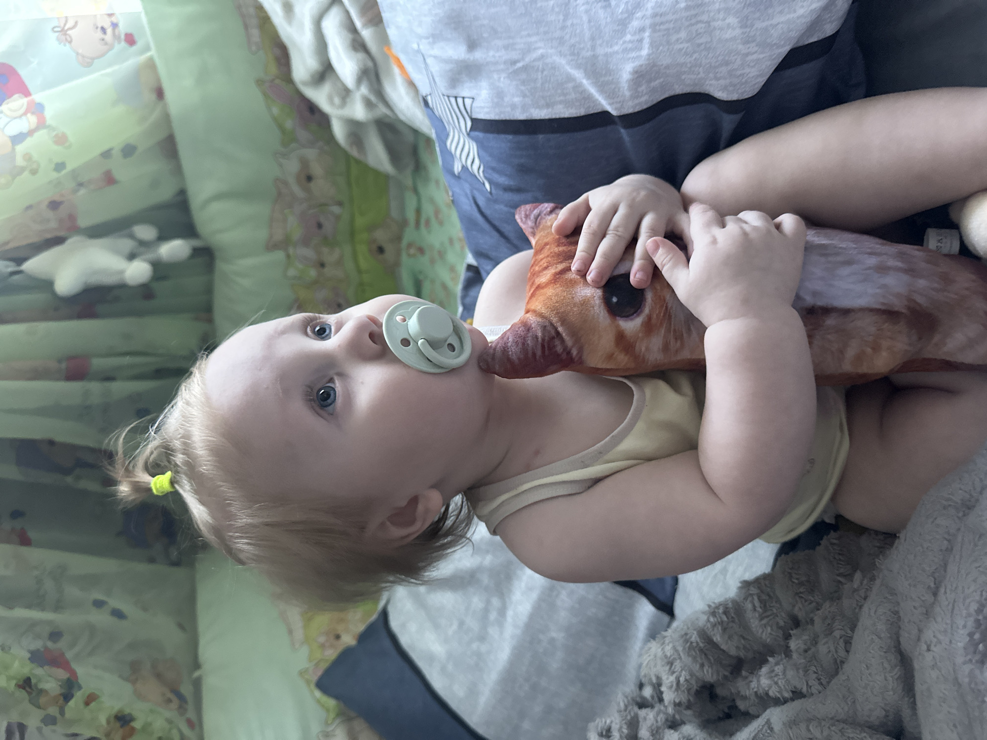 Toddler playtime on a bed in Sayanogorsk, Russia