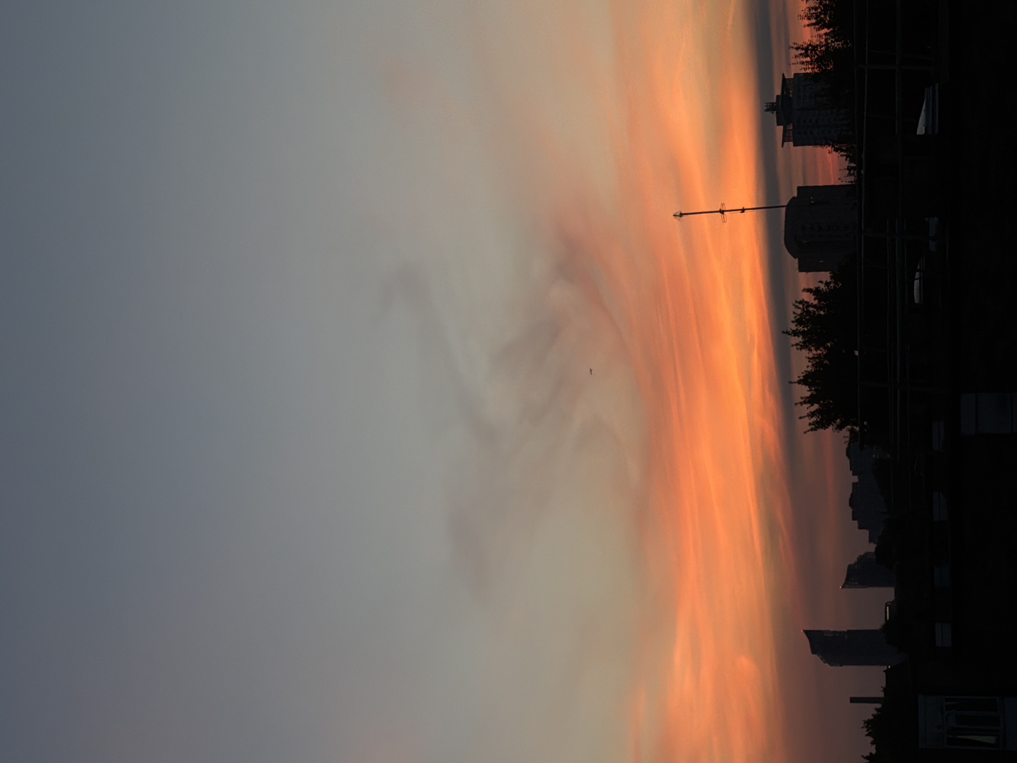 London solstice sunset watched from a city balcony