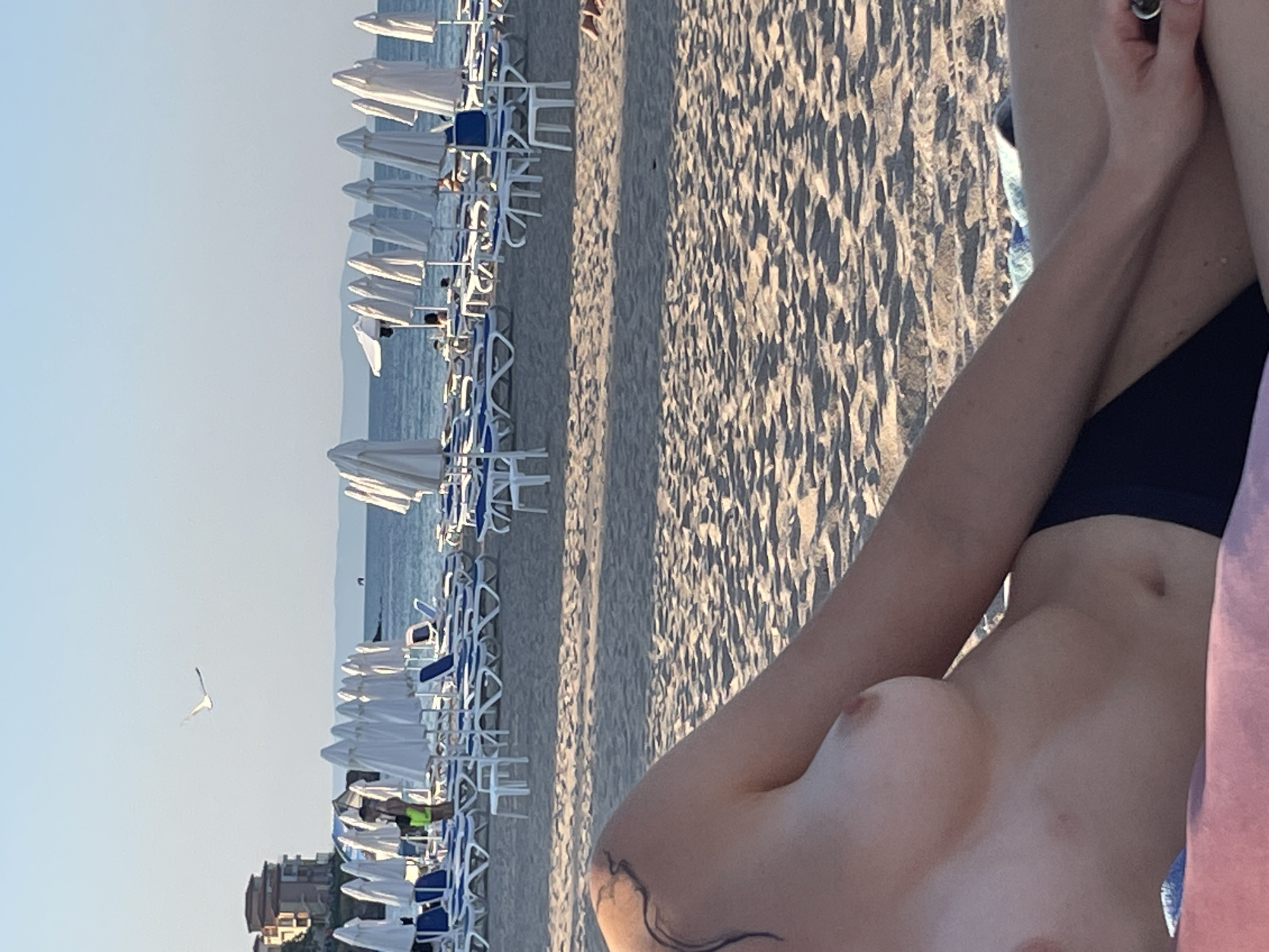 Relaxing at a branded beach club with lounge chairs and umbrellas