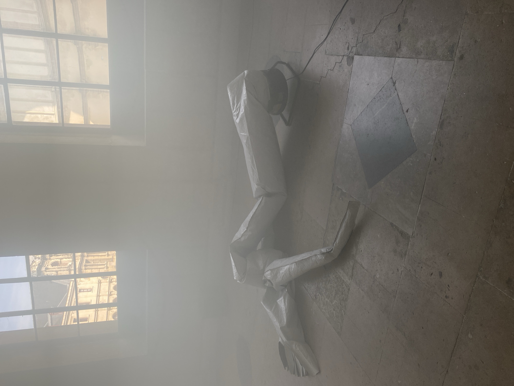 Smoke-filled Paris building interior with deflated inflatable documented