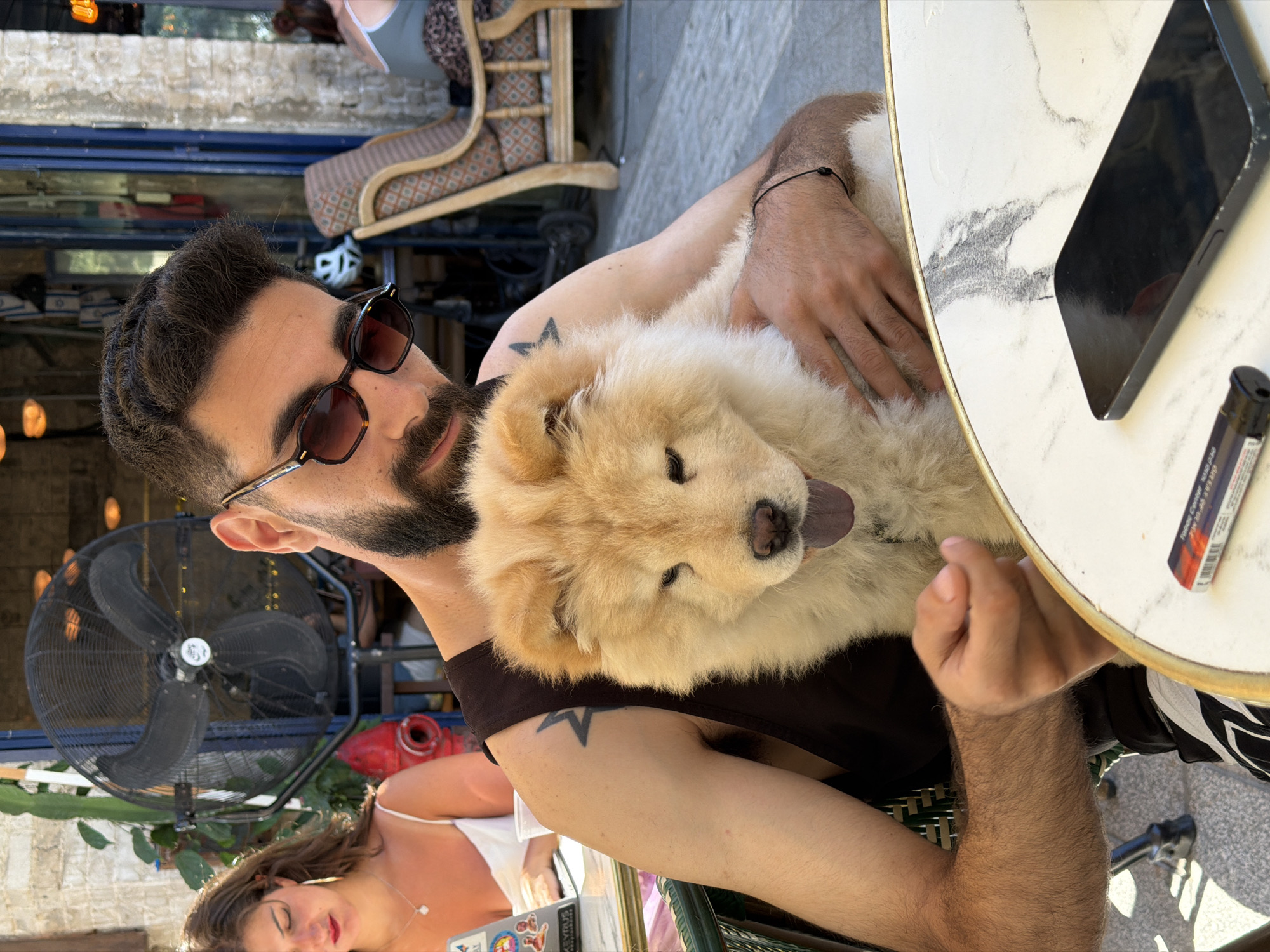 Man shares tender moment with Chow Chow at Tel-Aviv cafe