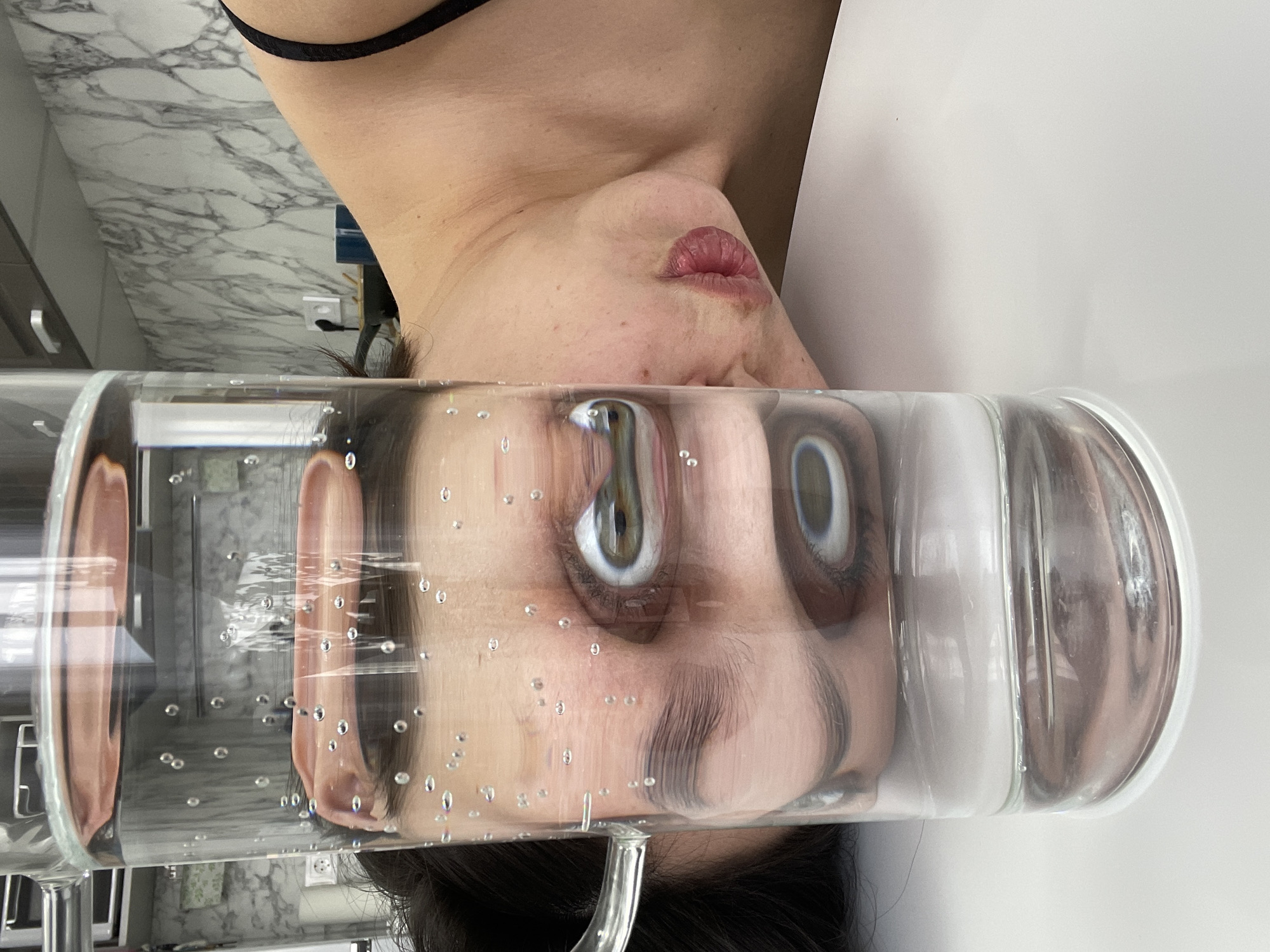 Woman documents breakfast with artistic water glass photography in Izhevsk