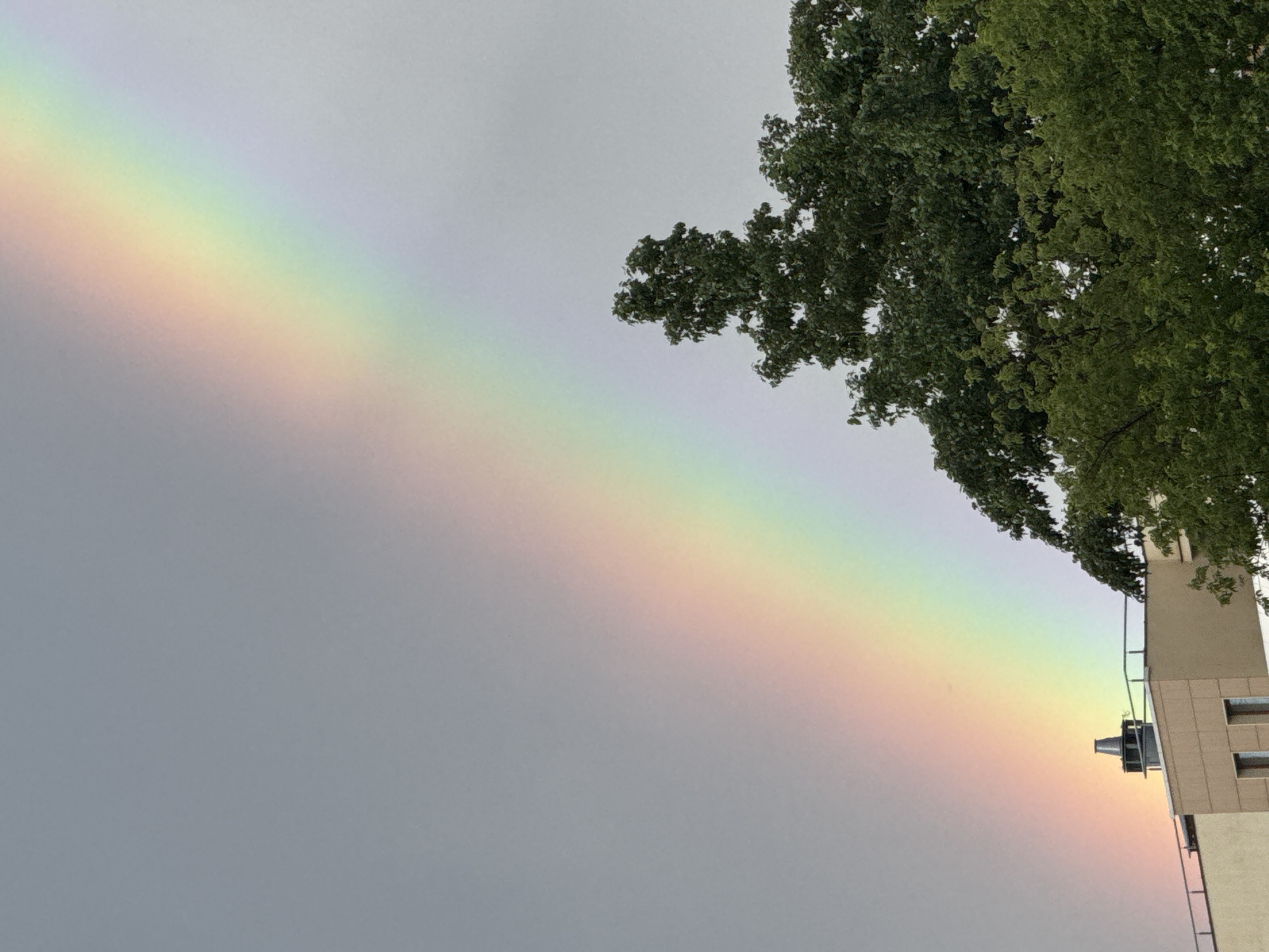 Rainbow over Moscow on a cloudy June afternoon