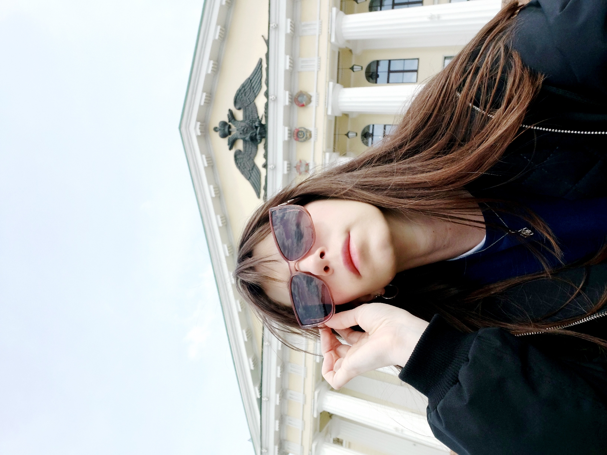 Woman photographed at classical building and waterfront location