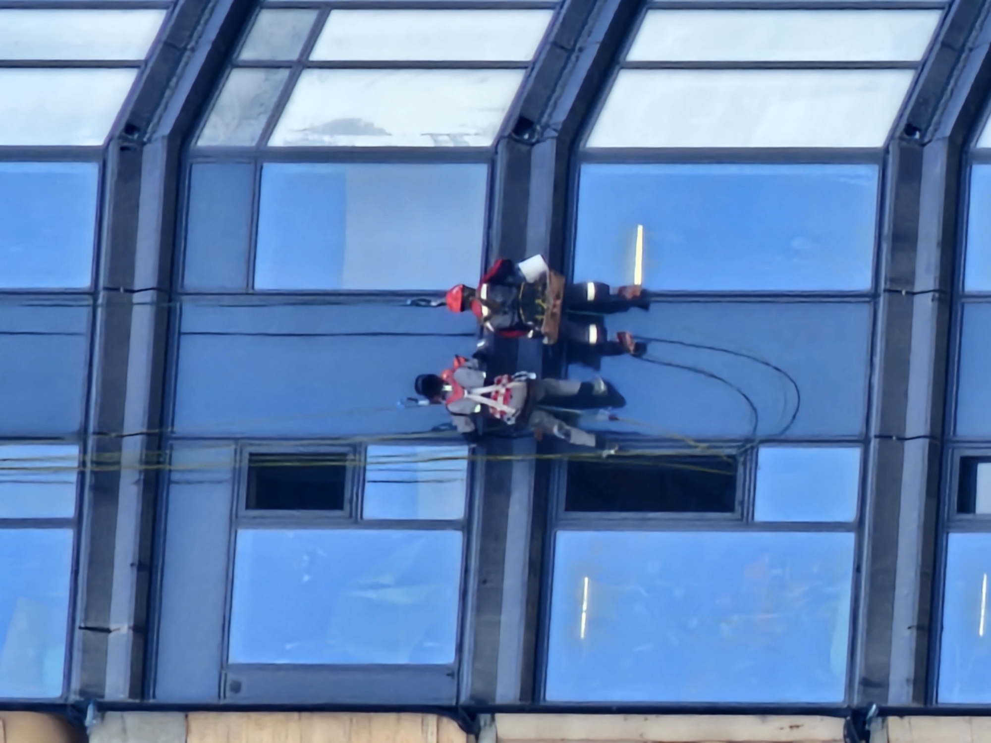 Window cleaners work a Moscow glass tower at dawn