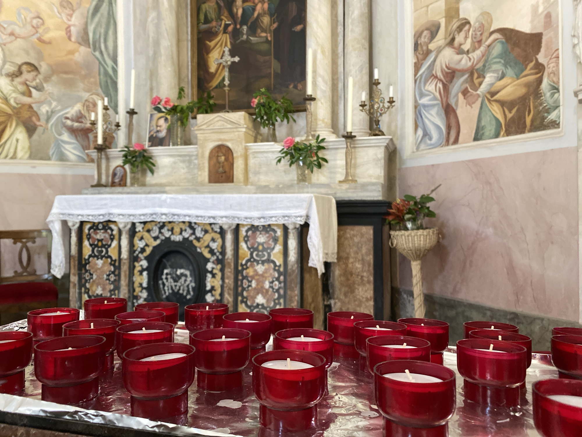 Tourist documents church interior and colorful streets in Lugano