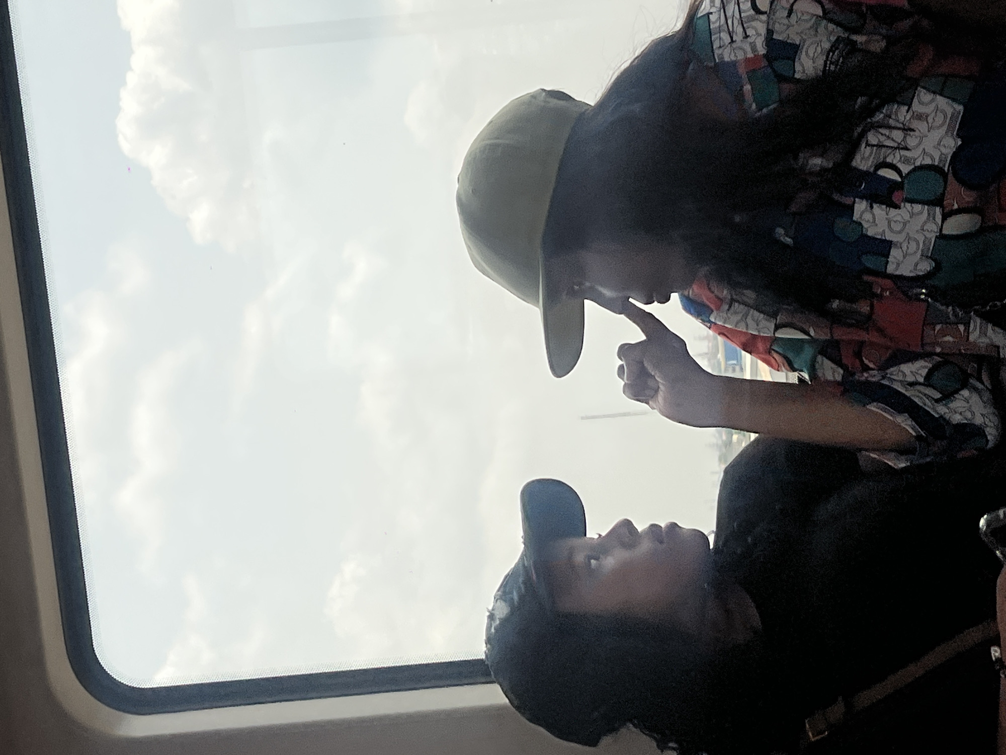 Two people share moment by window in Lagos