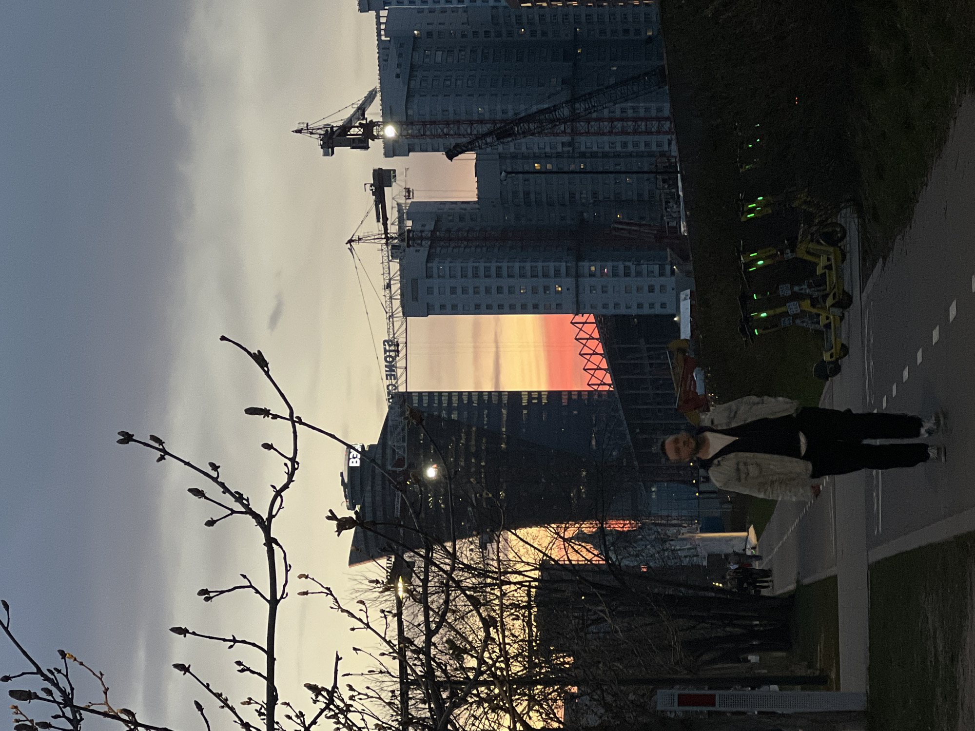 Person observed on Moscow sidewalk during sunset amid construction