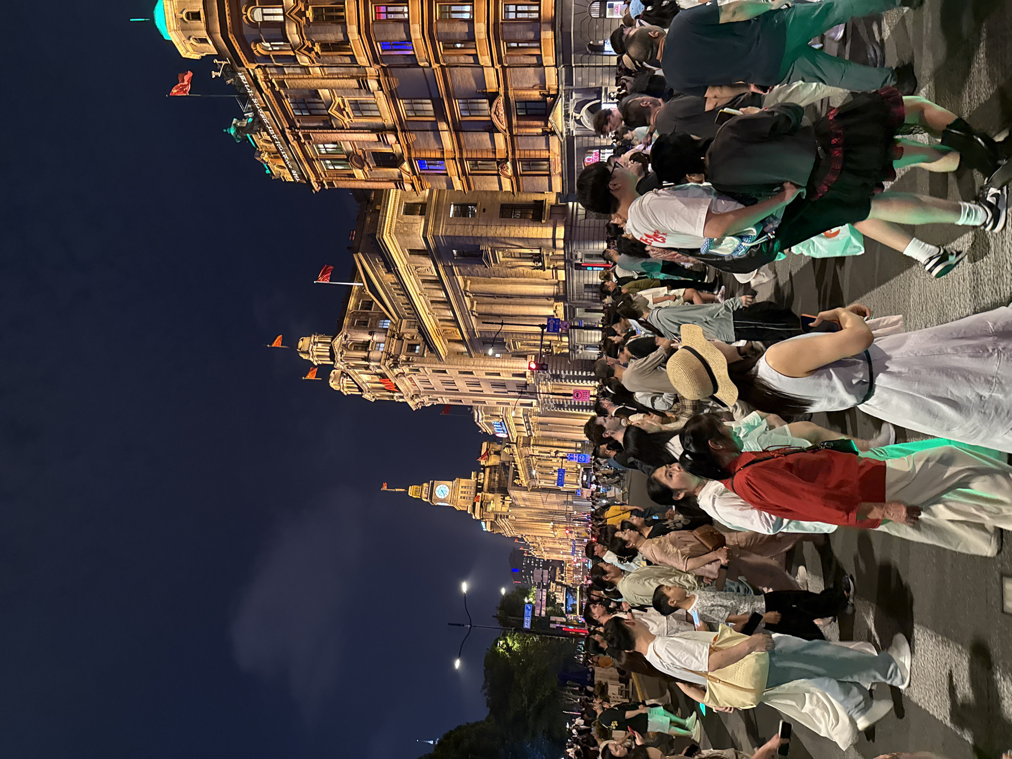 Nighttime crowds fill Shanghai's illuminated commercial districts