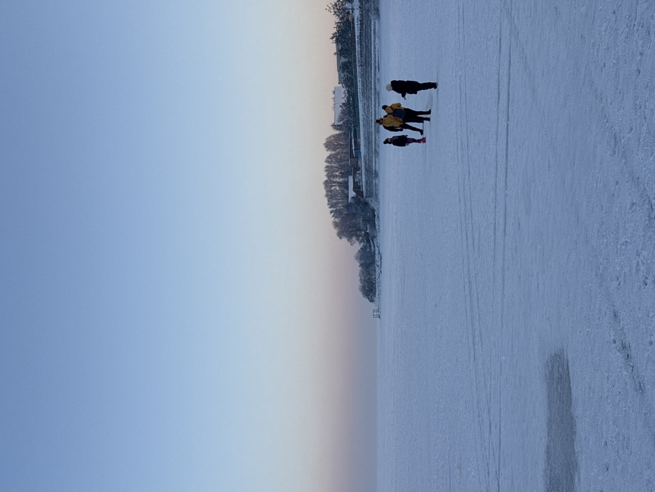 Woman walks frozen lake in Ukraine winter scene