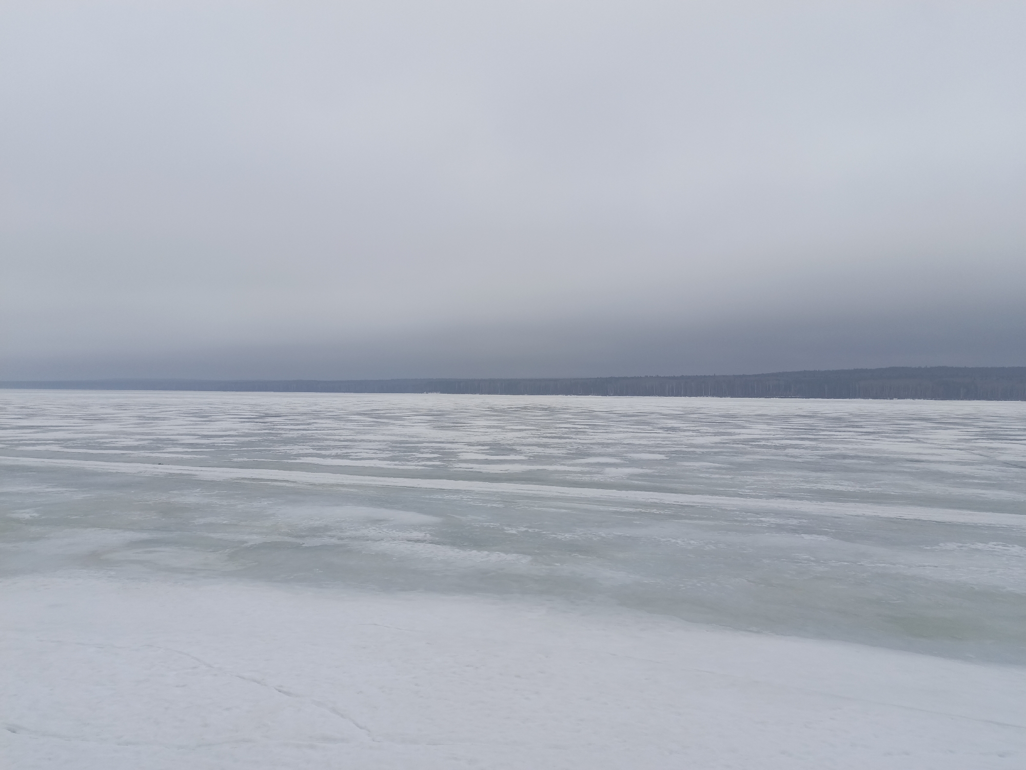 Man visits chess tables at frozen lakeside park in Russia