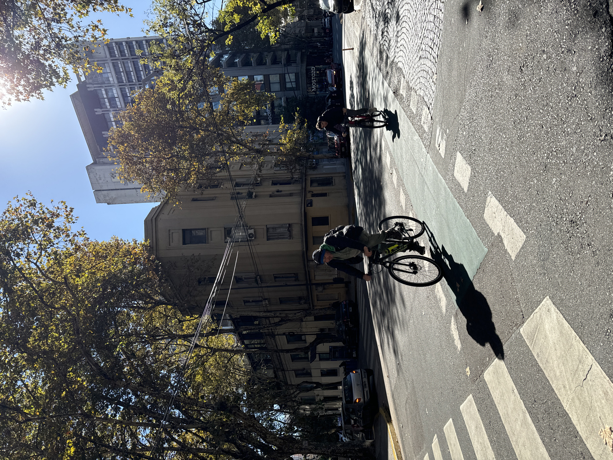 Cyclists navigate Buenos Aires streets amid typical urban activity