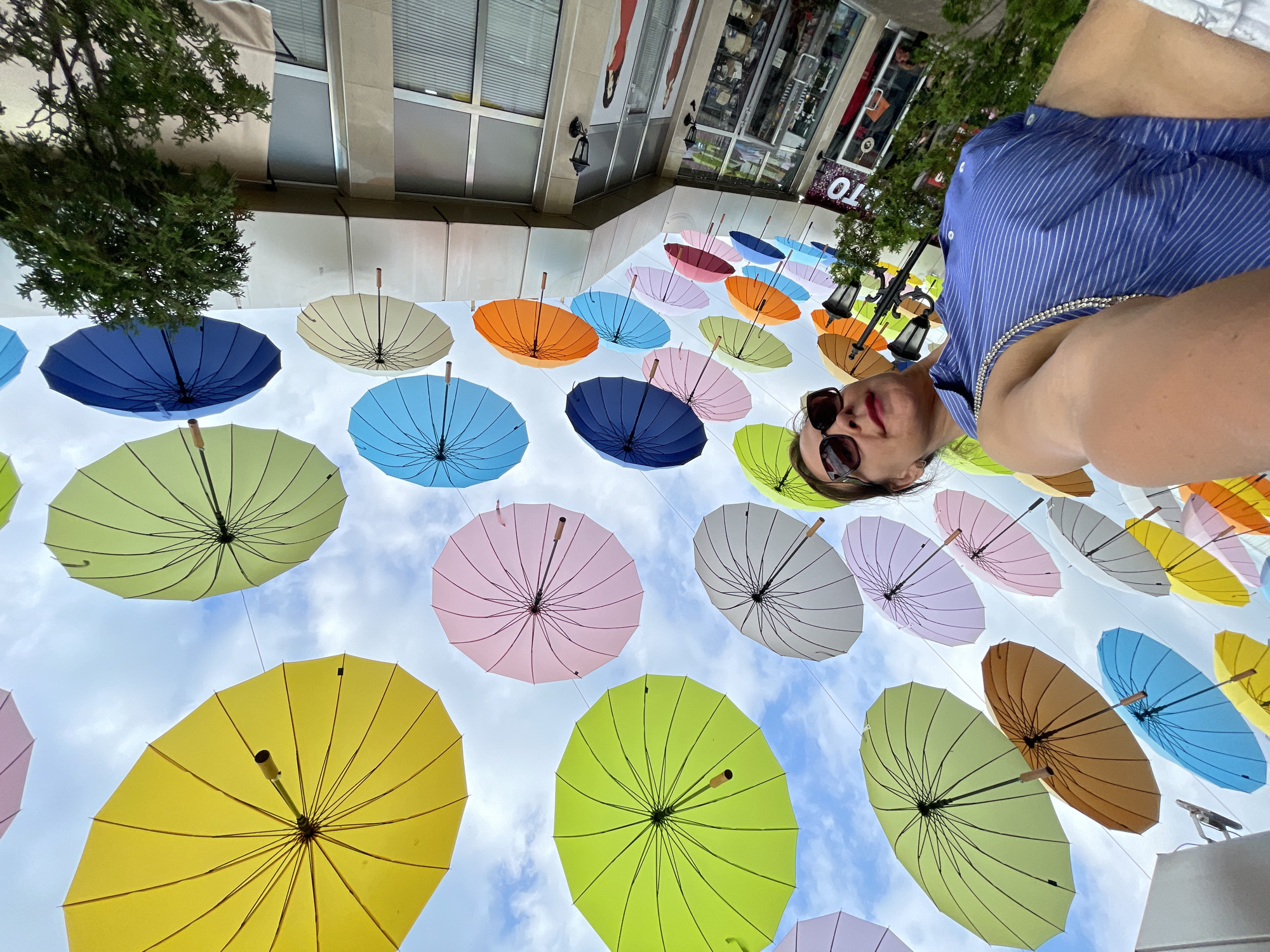 Sochi promenade: umbrella canopy, mirror attractions, and a macaw