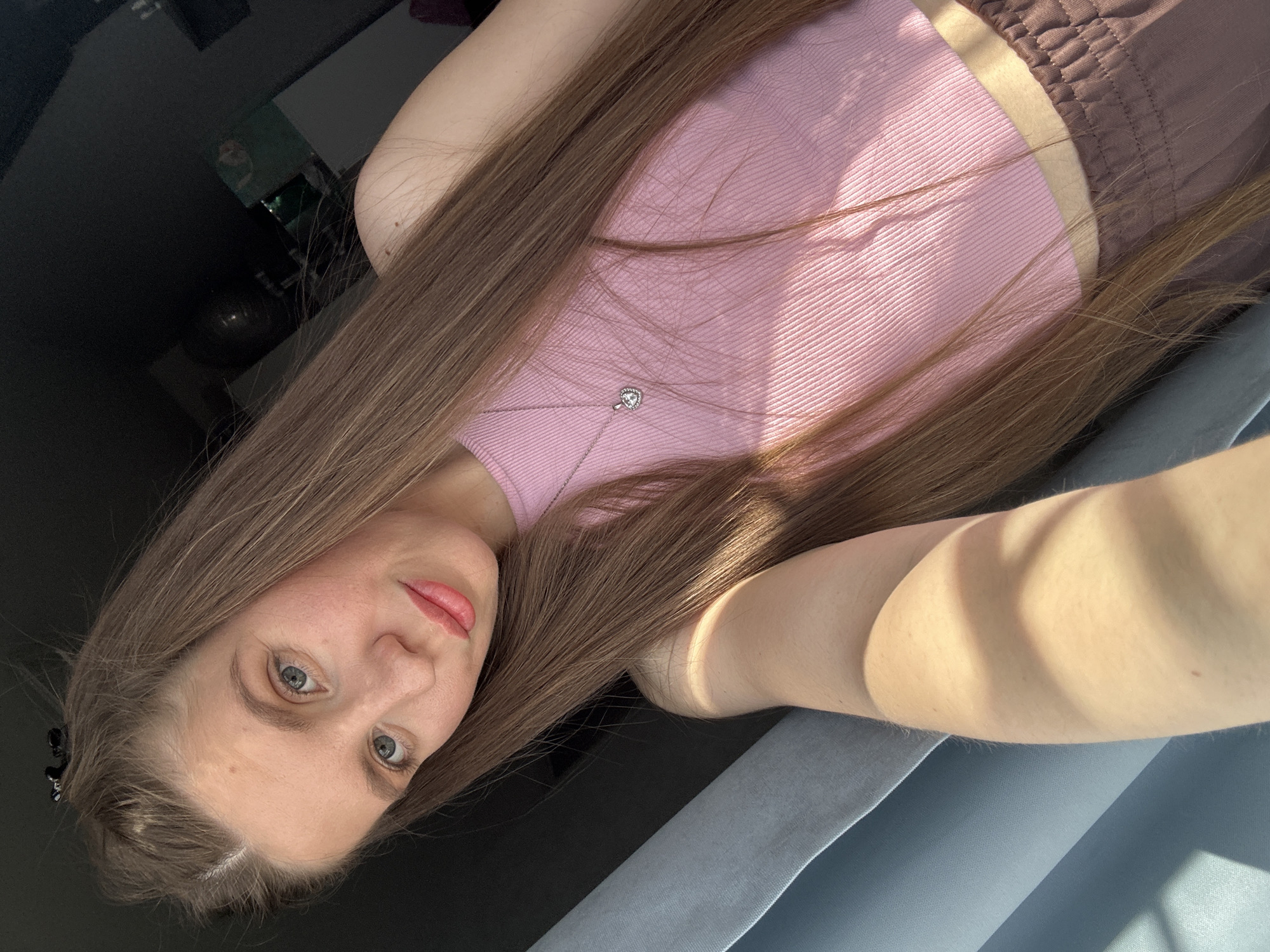 Woman takes selfies in pink top in Klin, Russia