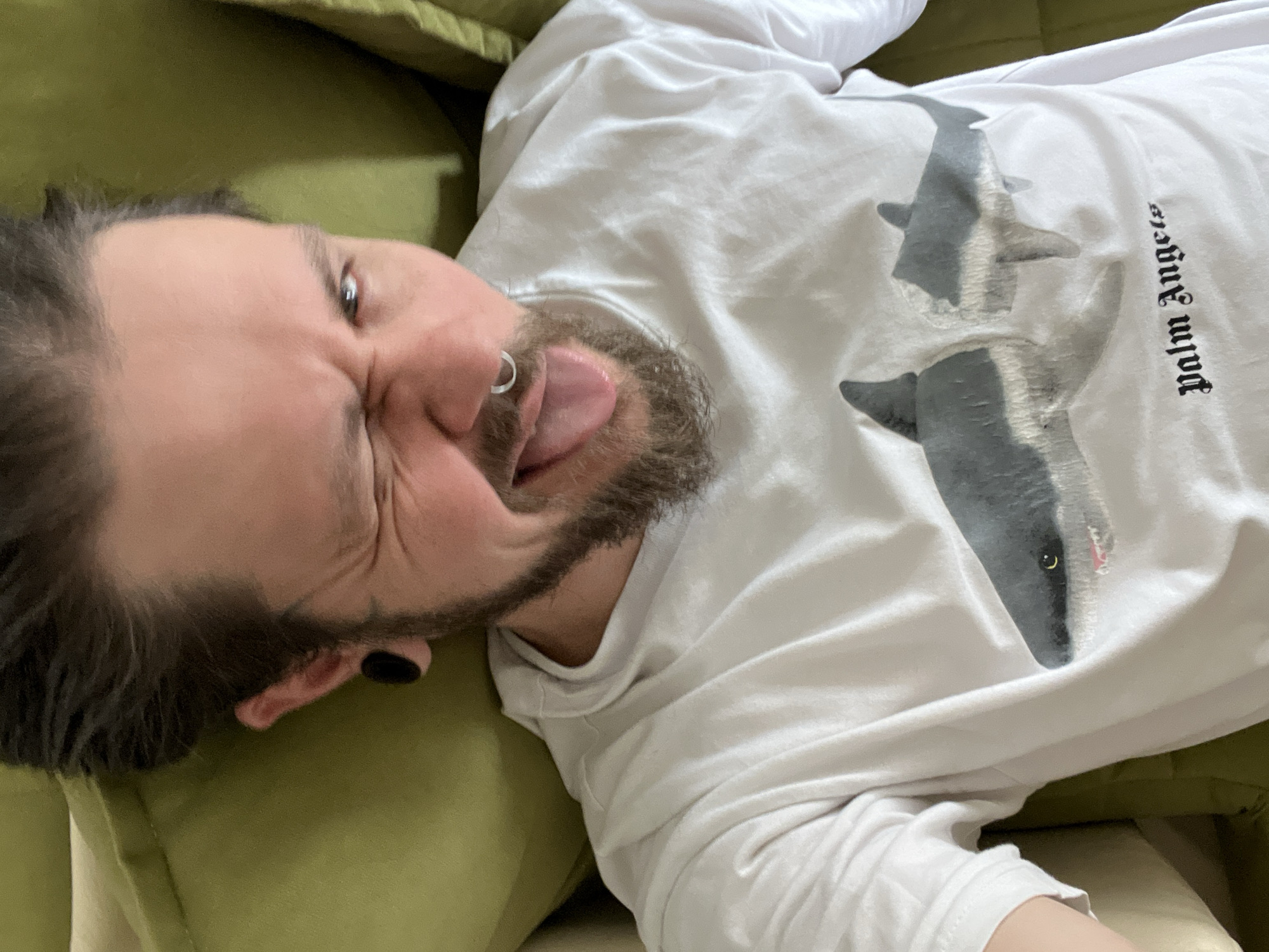 Man makes playful face on sofa in Montenegro