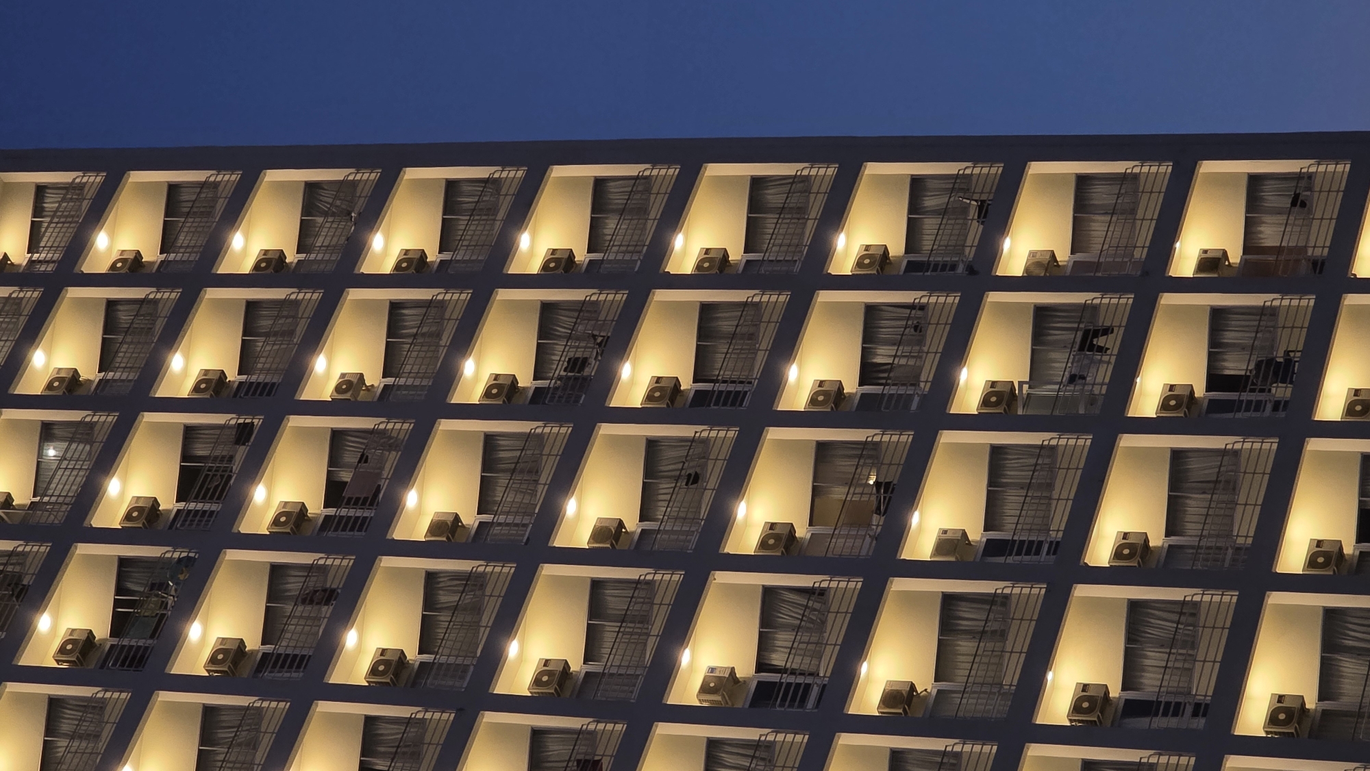 Evening lights illuminate Nha Trang buildings during twilight hours