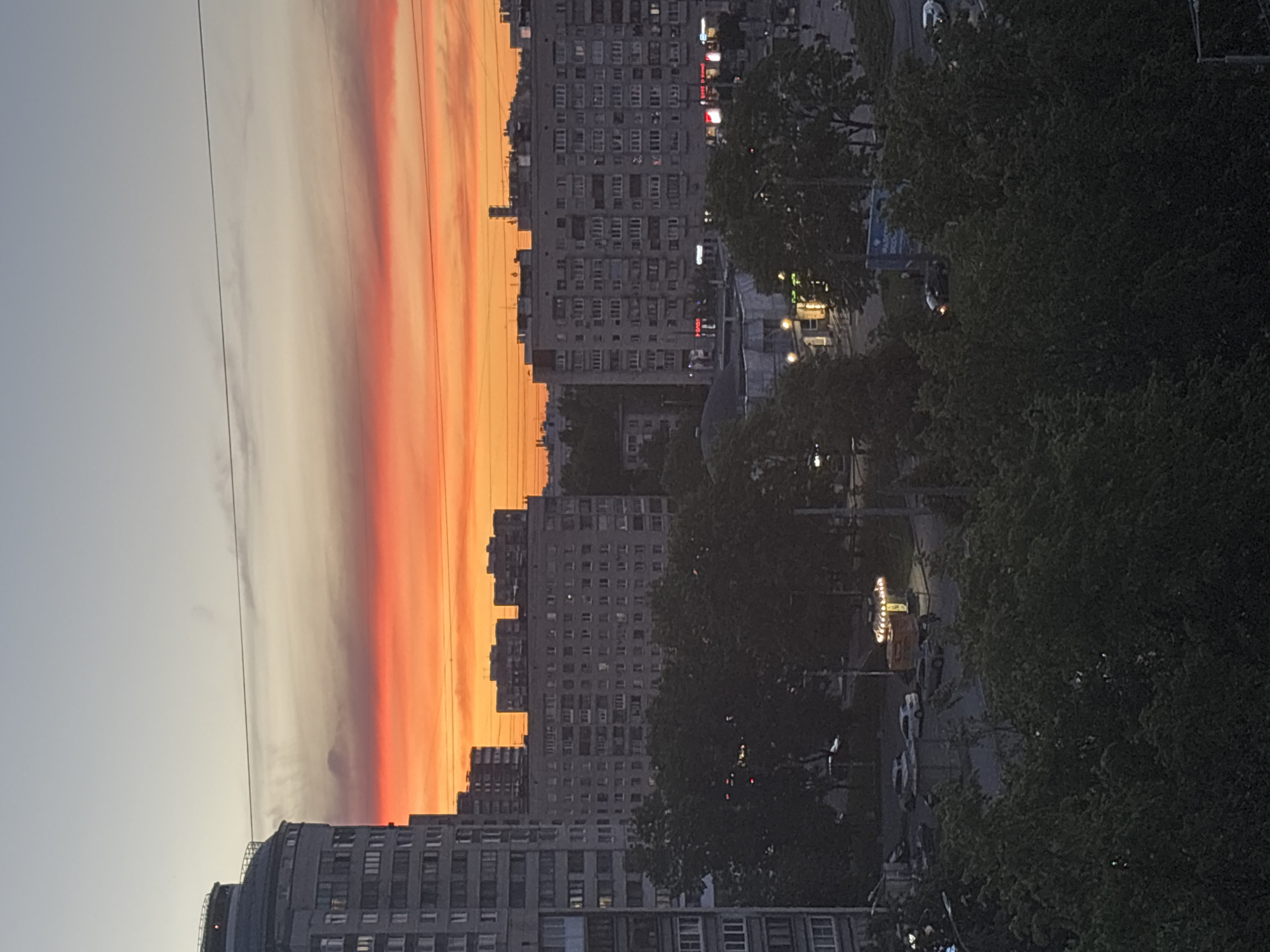 Dramatic sunset illuminates Russian lakeside city skyline